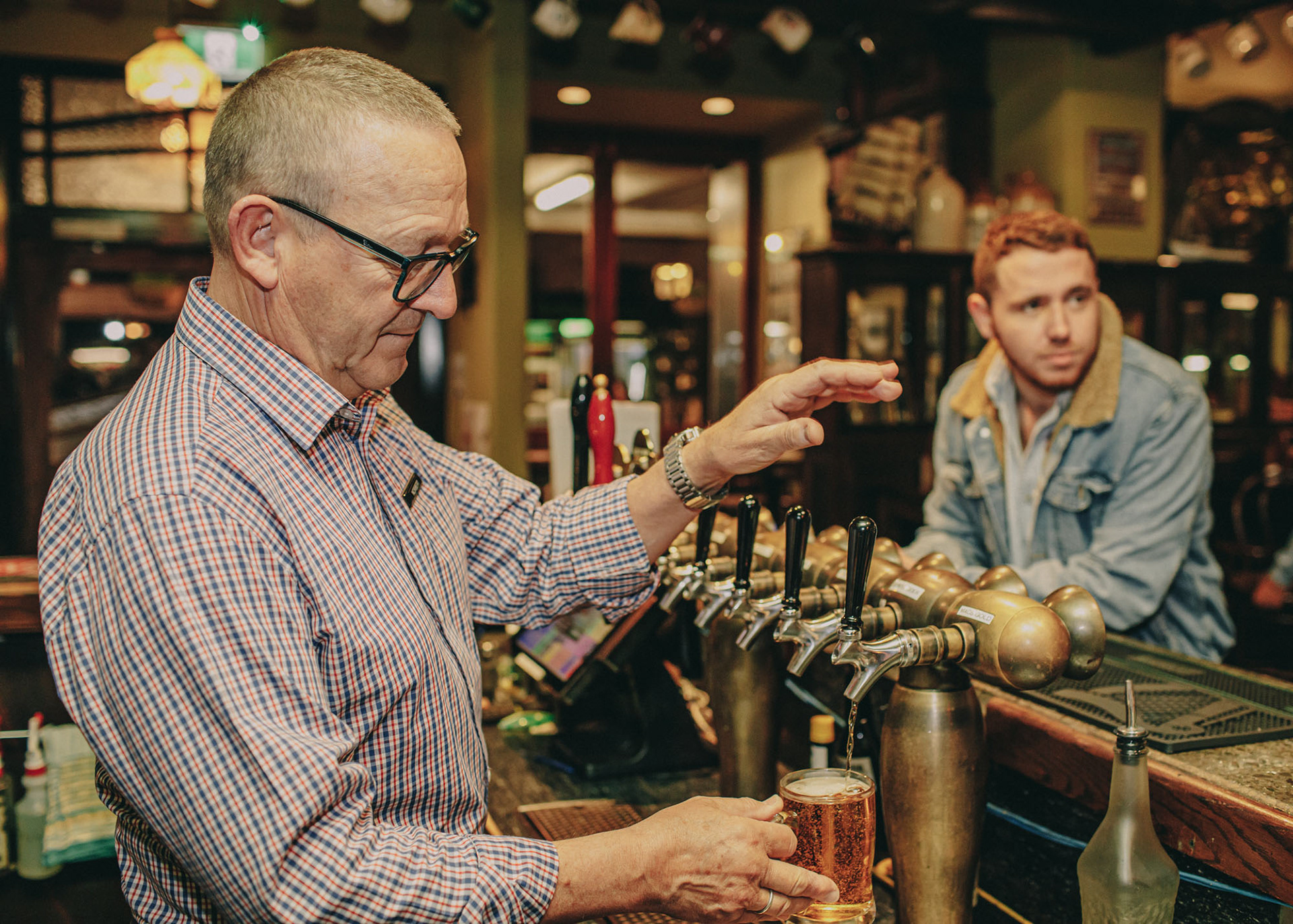 Graham pouring a beer at The Rose