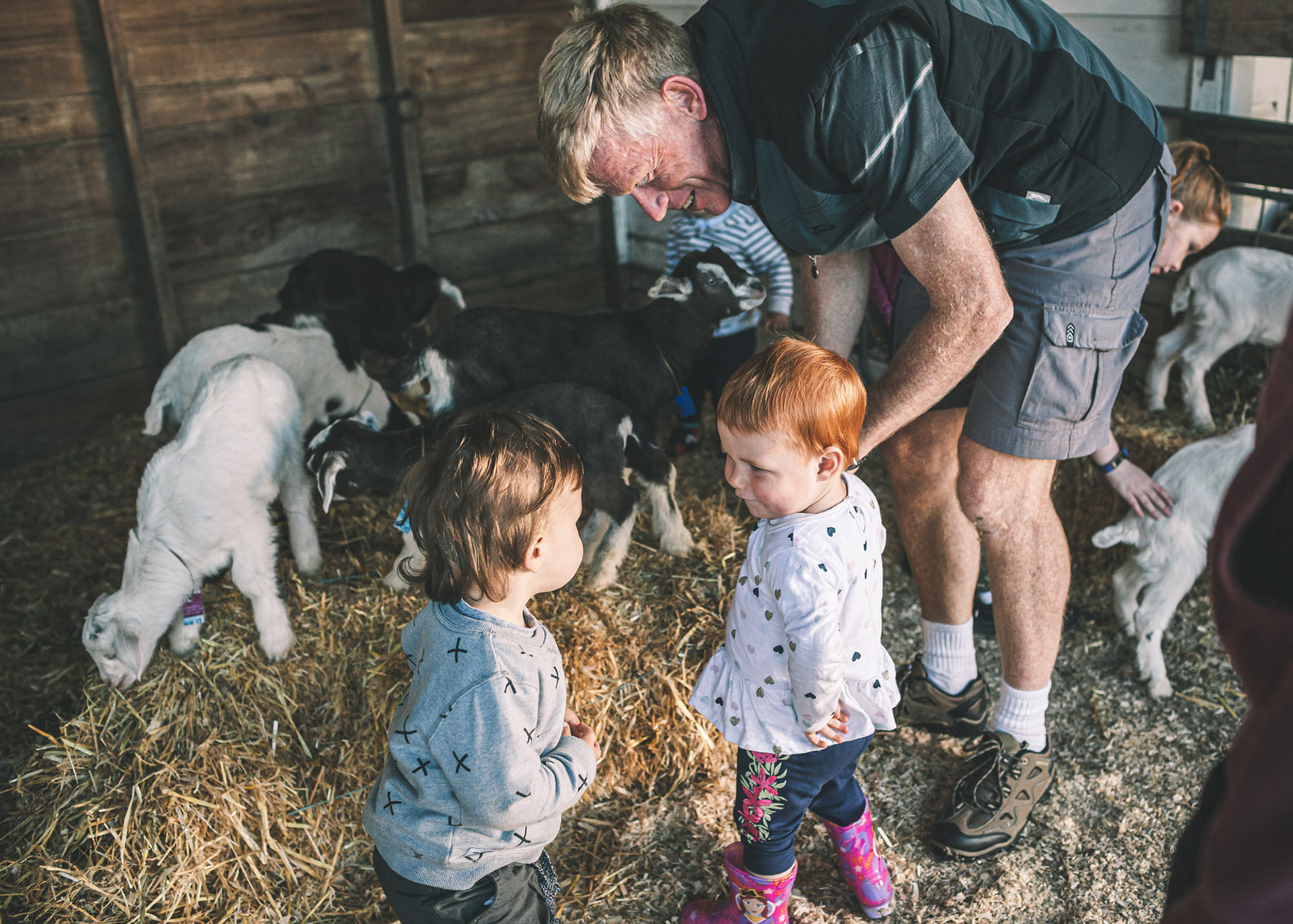 Little children enjoying the little baby goats at the Petting Zoo
