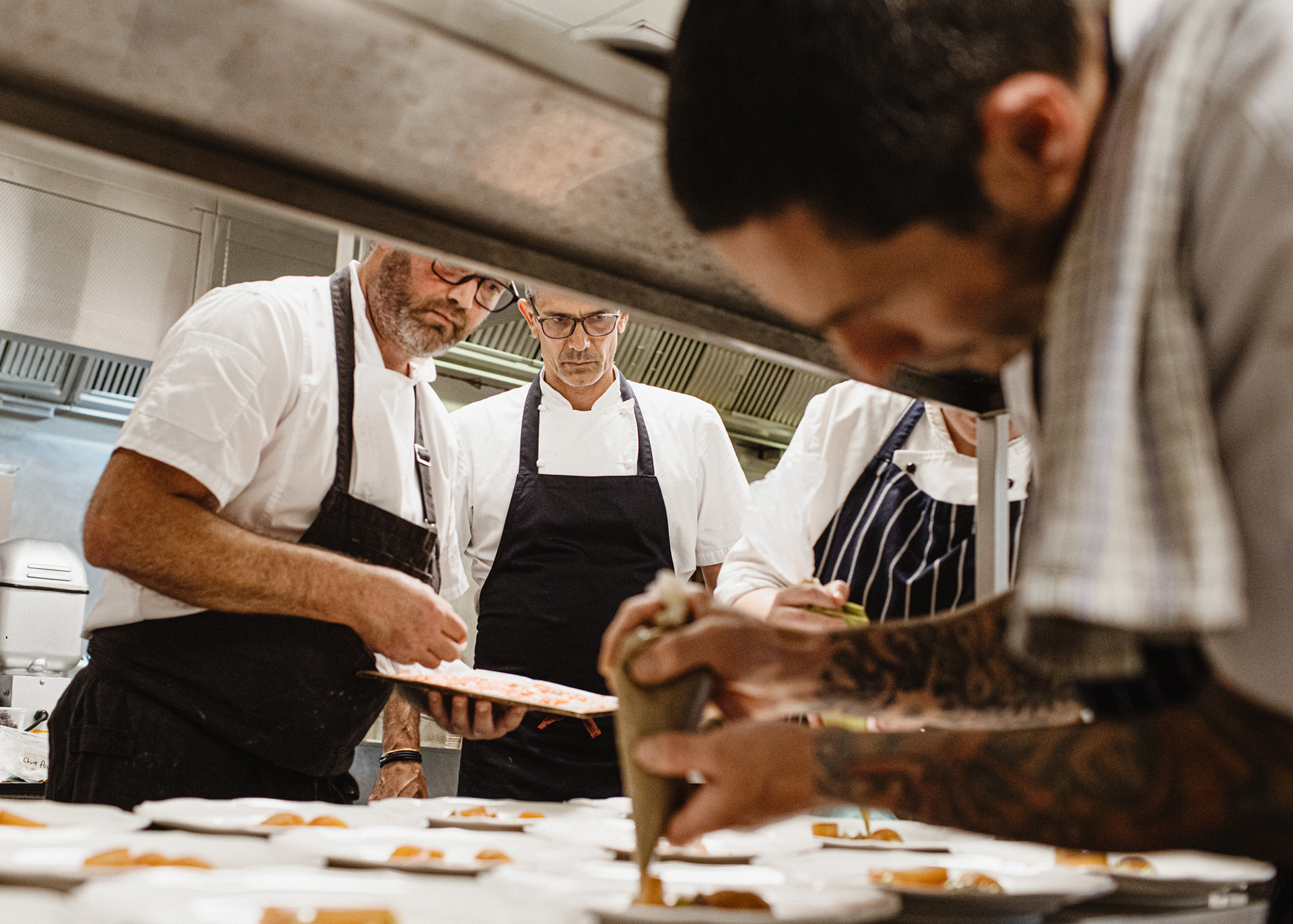 Chefs James Honores and Josh Emett plating a course at The Farm Cape Kidnappers.