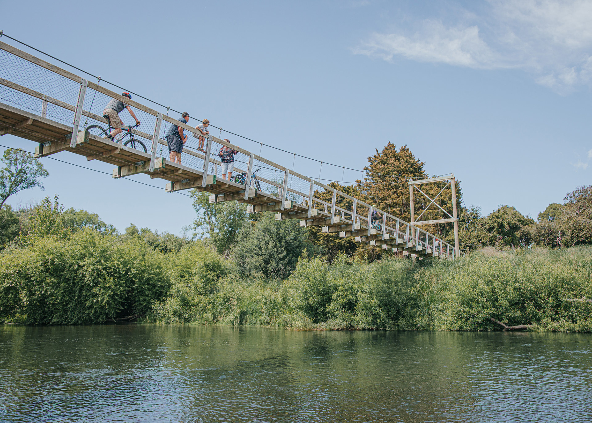 Cyclists and families enjoying the Central Hawke's Bay suspended bridge