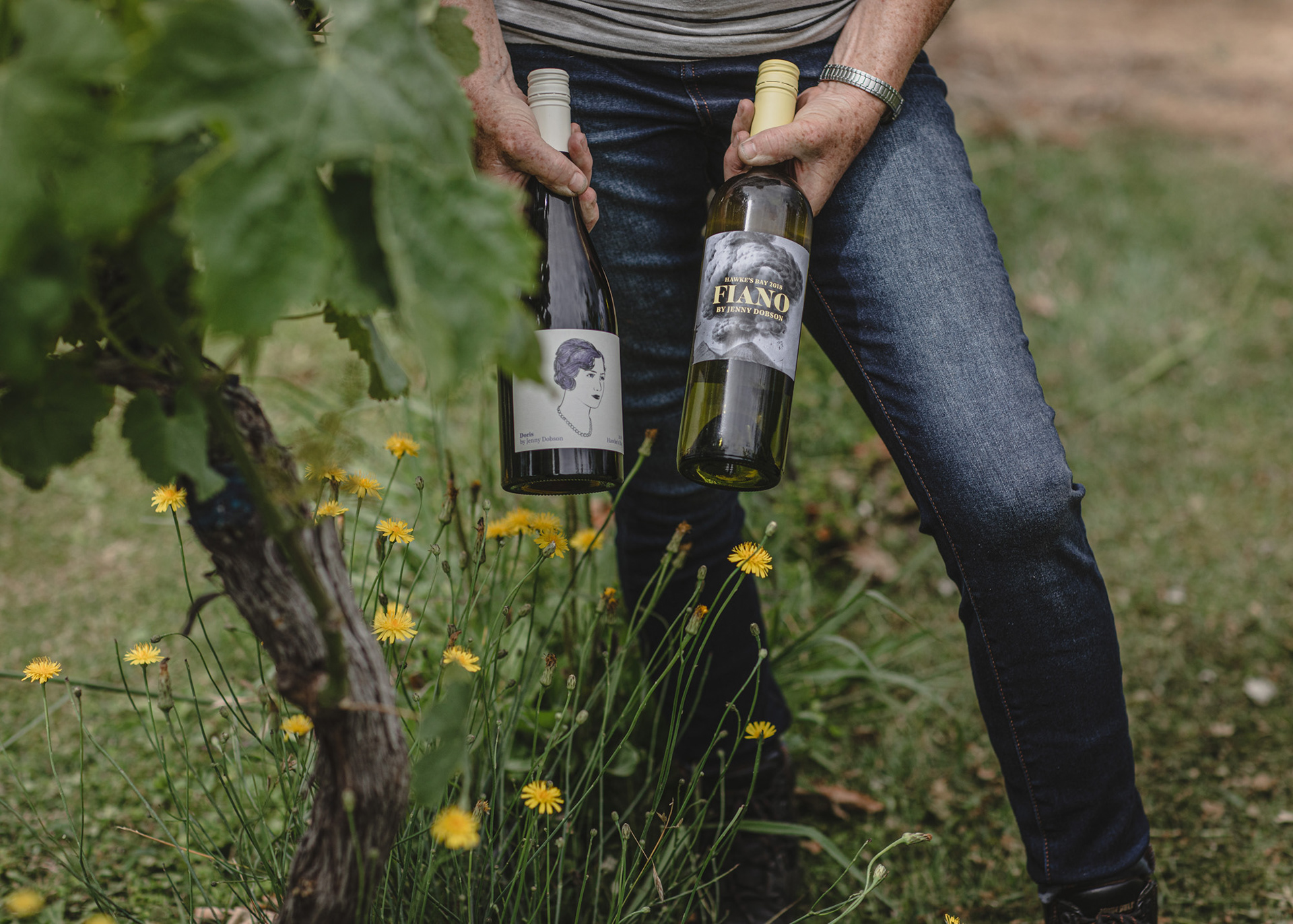 Winemaker Jenny Dobson holding two of her wine variety's Fiano and Doris