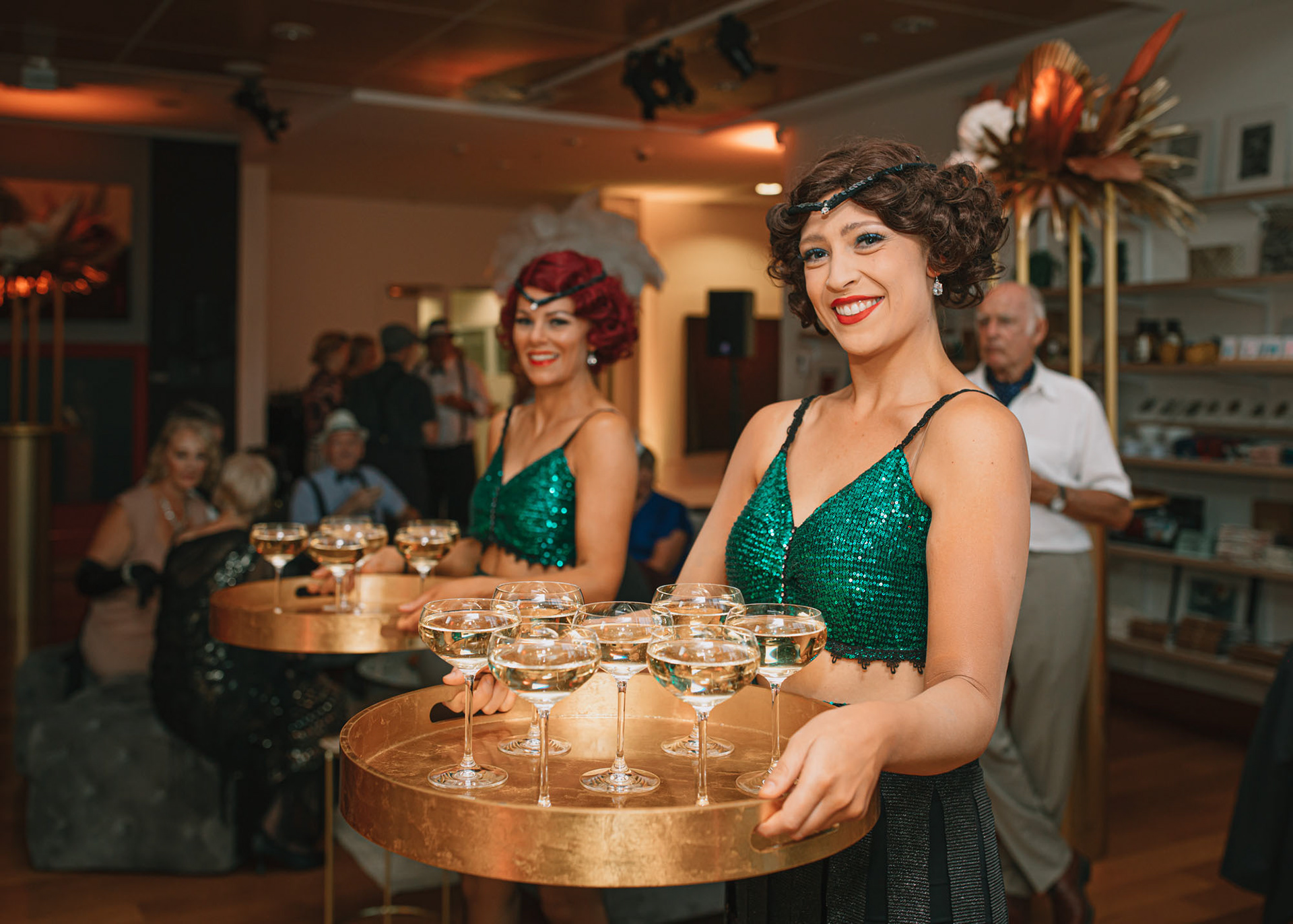 Deco Dancers serve guests bubbles on arrival