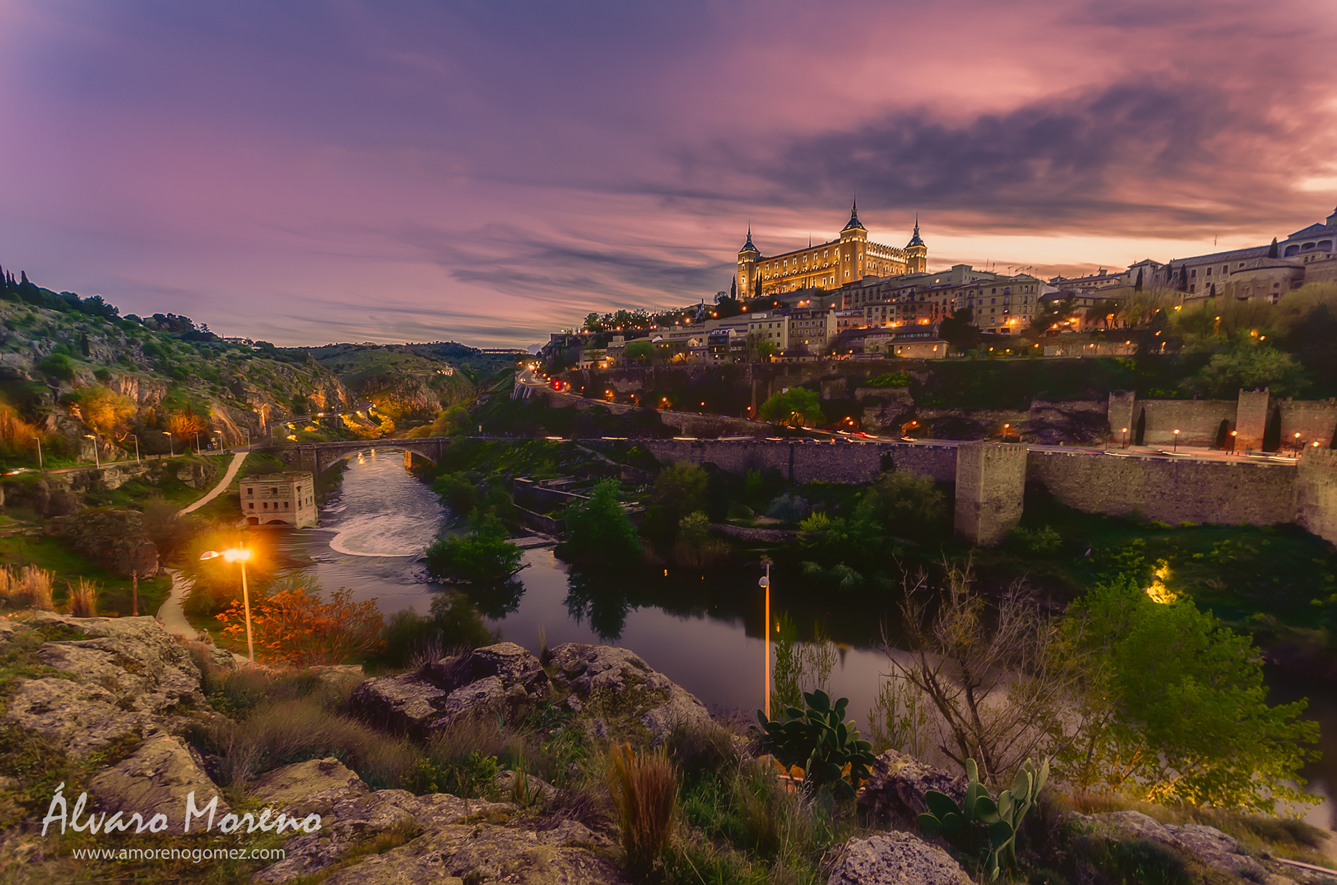 Toledo seen from the other side of the Tagus River at sunset with the Alcázar de Toledo illuminated
