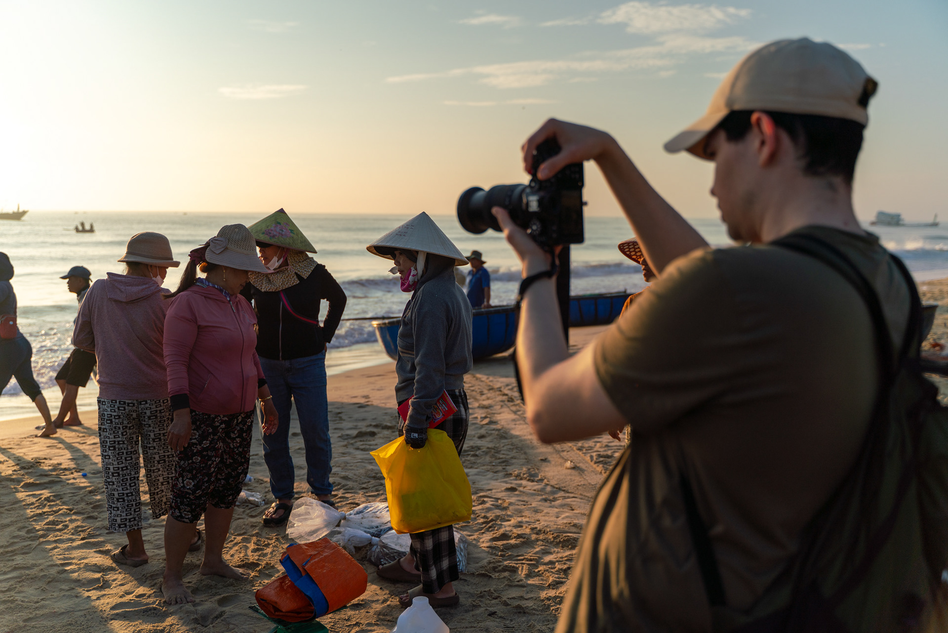 Photographer documenting fishermen and fish markets near Hoi An, Vietnam.
