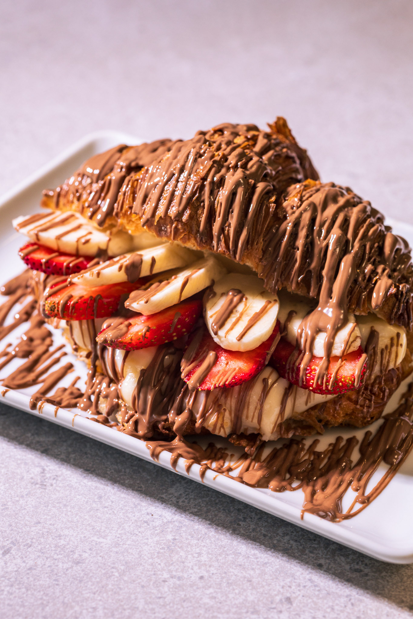 STRAWBERRY & BANANA CREAM CROISSANT Have you ever seen something so tasty in your life?! It's waiting for you to come discover. Maybe you can bring a friend and have two.