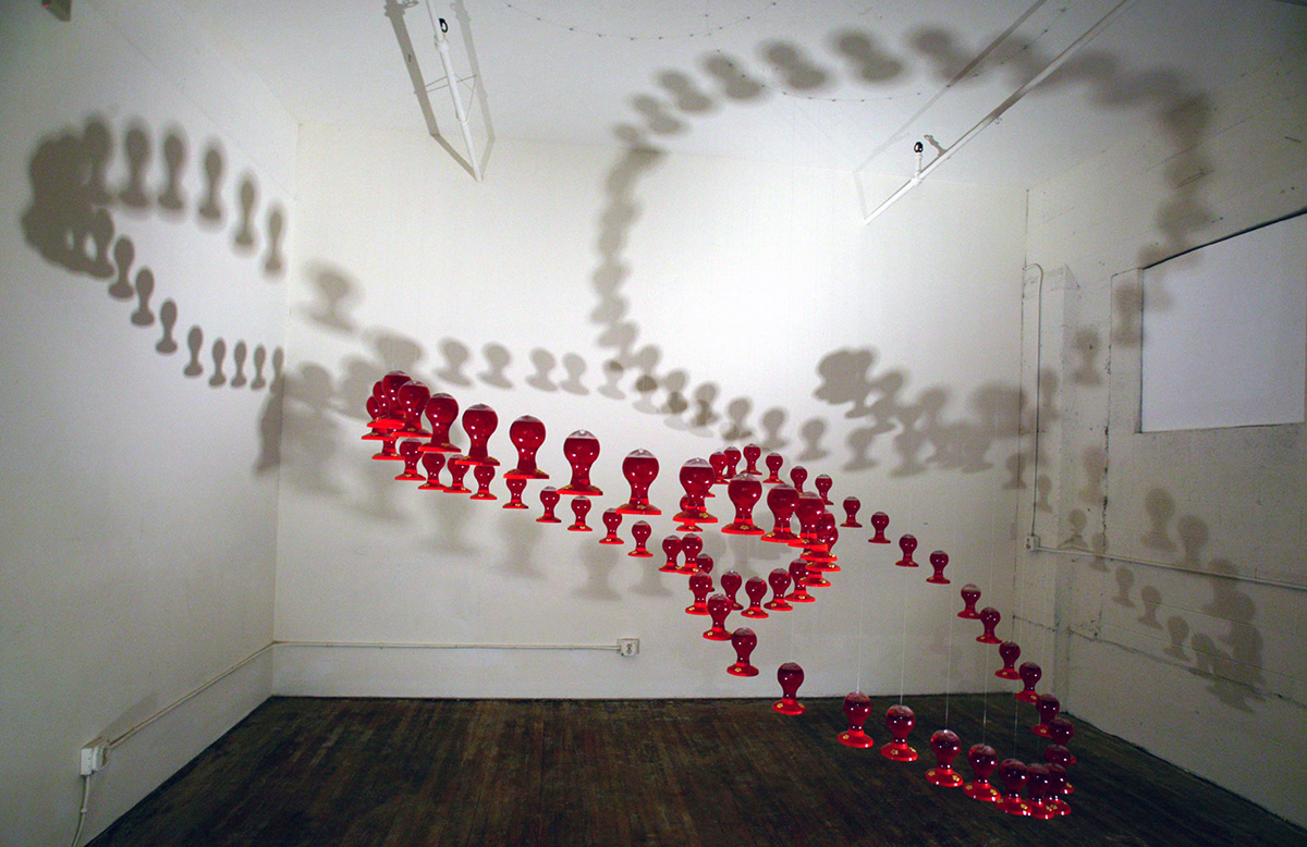 Cling . interlocking rings of hummingbird feeders in warehouse . Modern Zoo . PCAC . Cathedral Park Place . Portland, Oregon . 2003