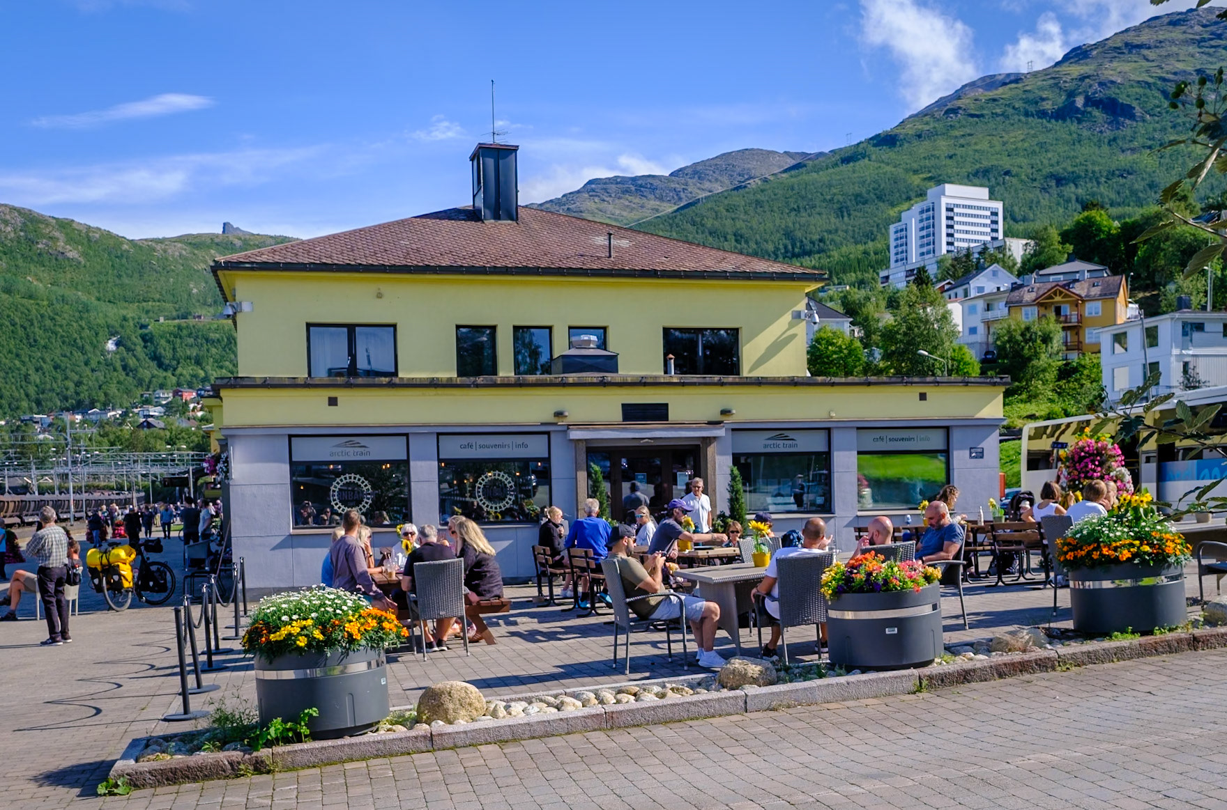 Unexpectedly mild weather - people sitting around in shorts at the Narvik train station!