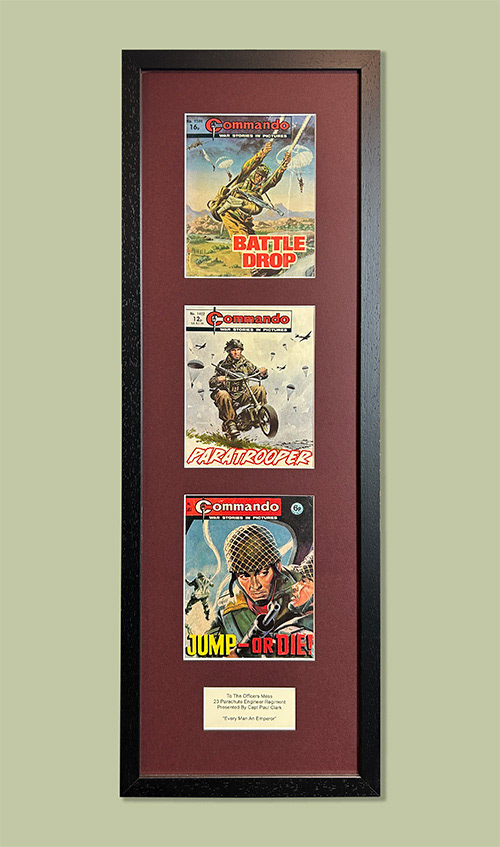 Three vintage commando magazines with presentation wording. Conservation framed
