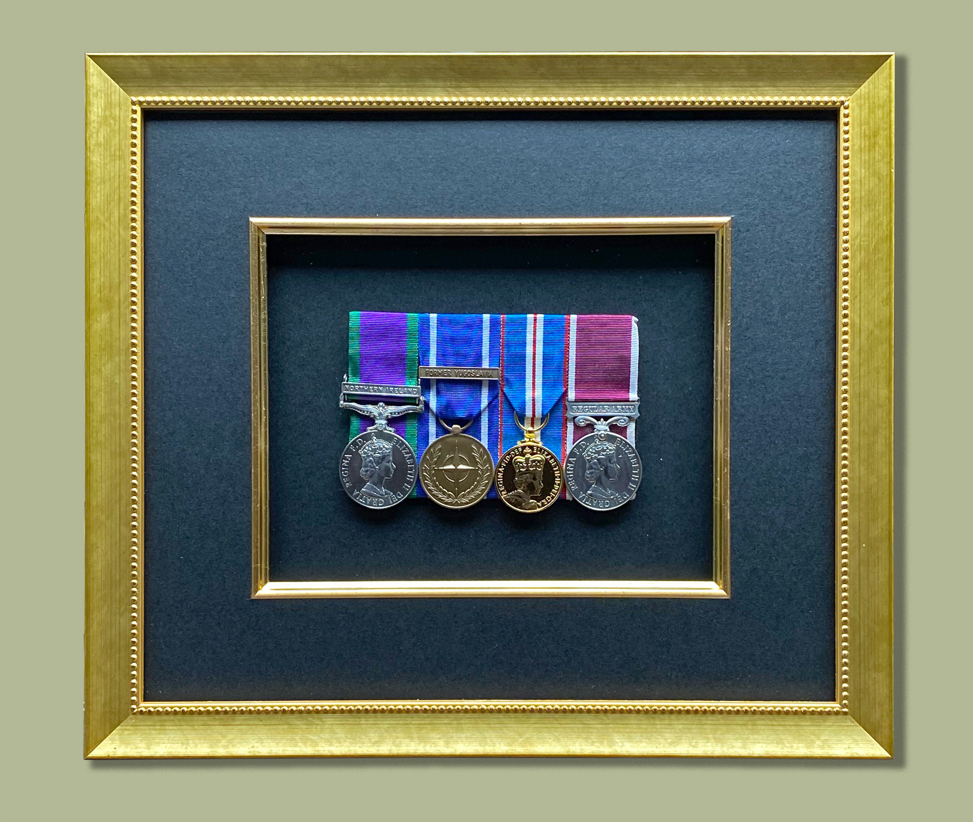 Framed Medal Case which allows mounted medals to be removed for wearing. Onyx Mount, Gold Fillet, Gold frame, Art Glass. Brass hinges and catch [Closed View]