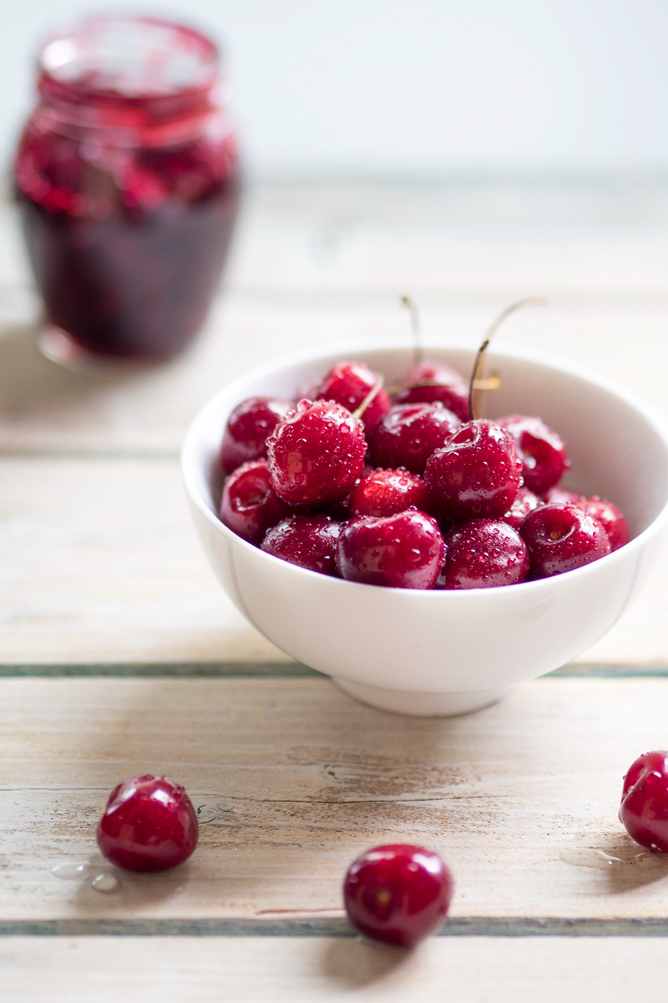 Čerešne a džem na bielom drevenom podklade - pohľad spredu - autor Jana Kollarova