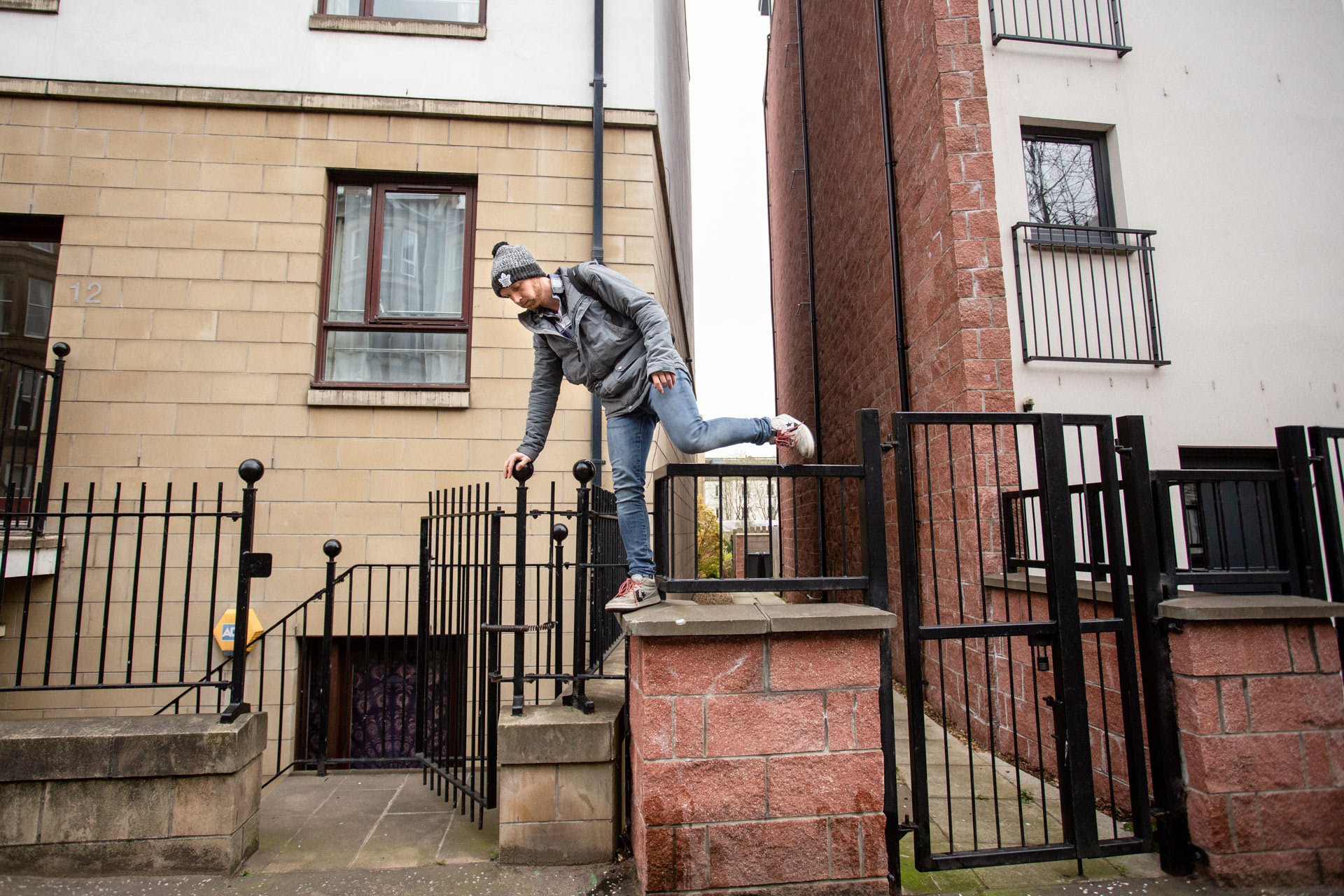 Matt crossing a fence as a shortcut from the parking lot where his van is.