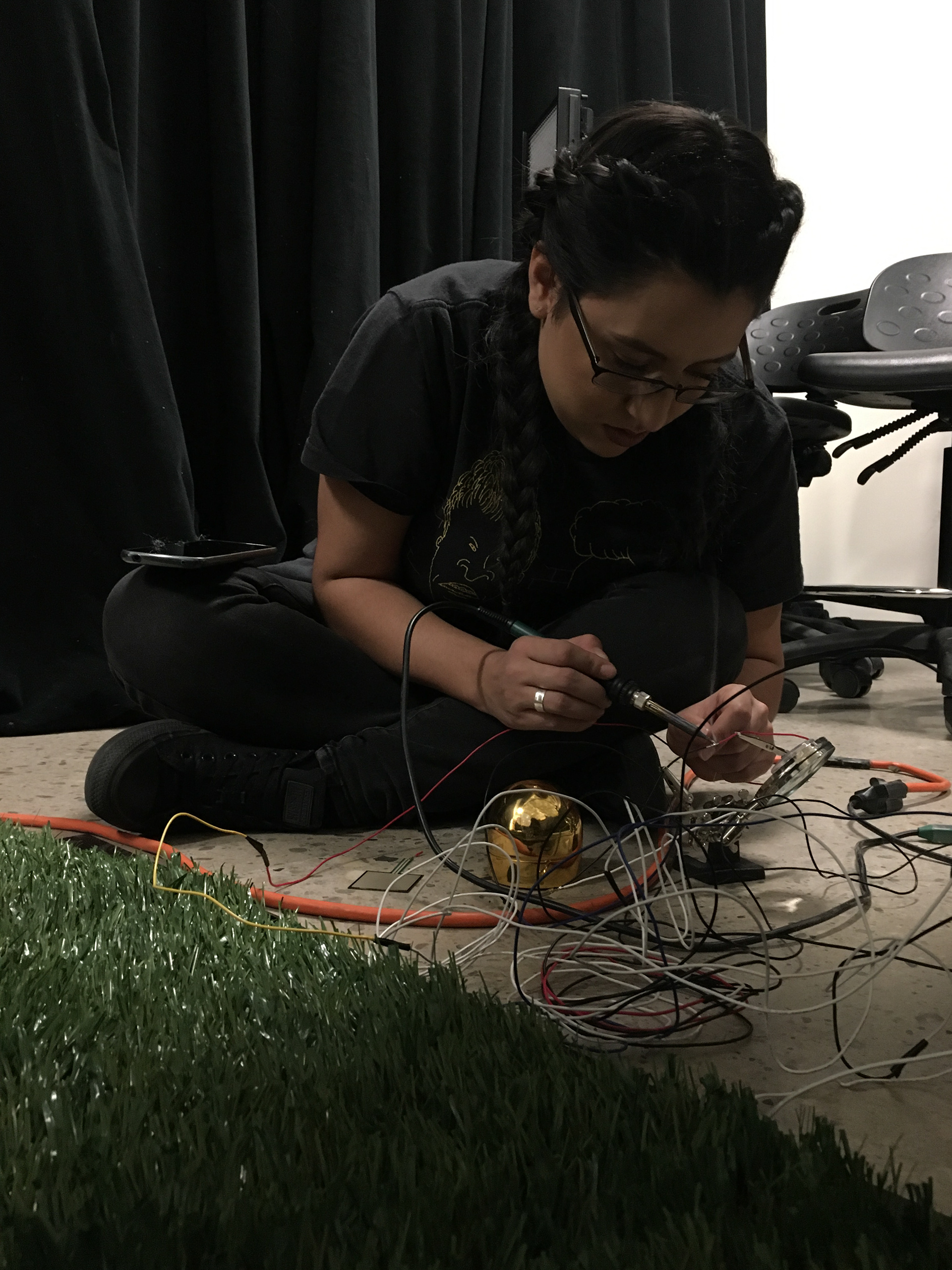 Myself soldering wire to an FSR pad
