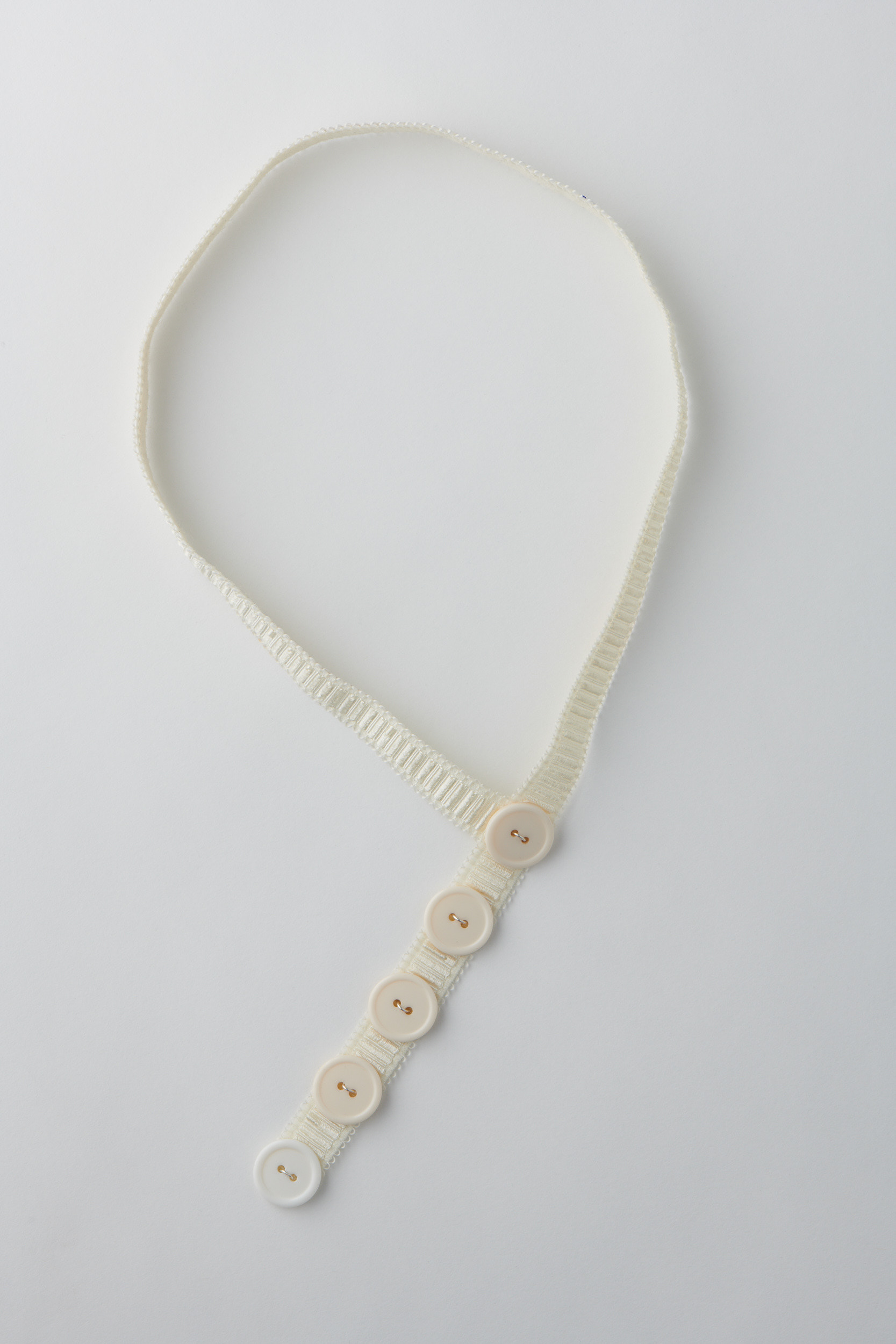 Preservation 4. Elastic with plastic buttons and silver. Photo by Fred Kroh, August 2021.