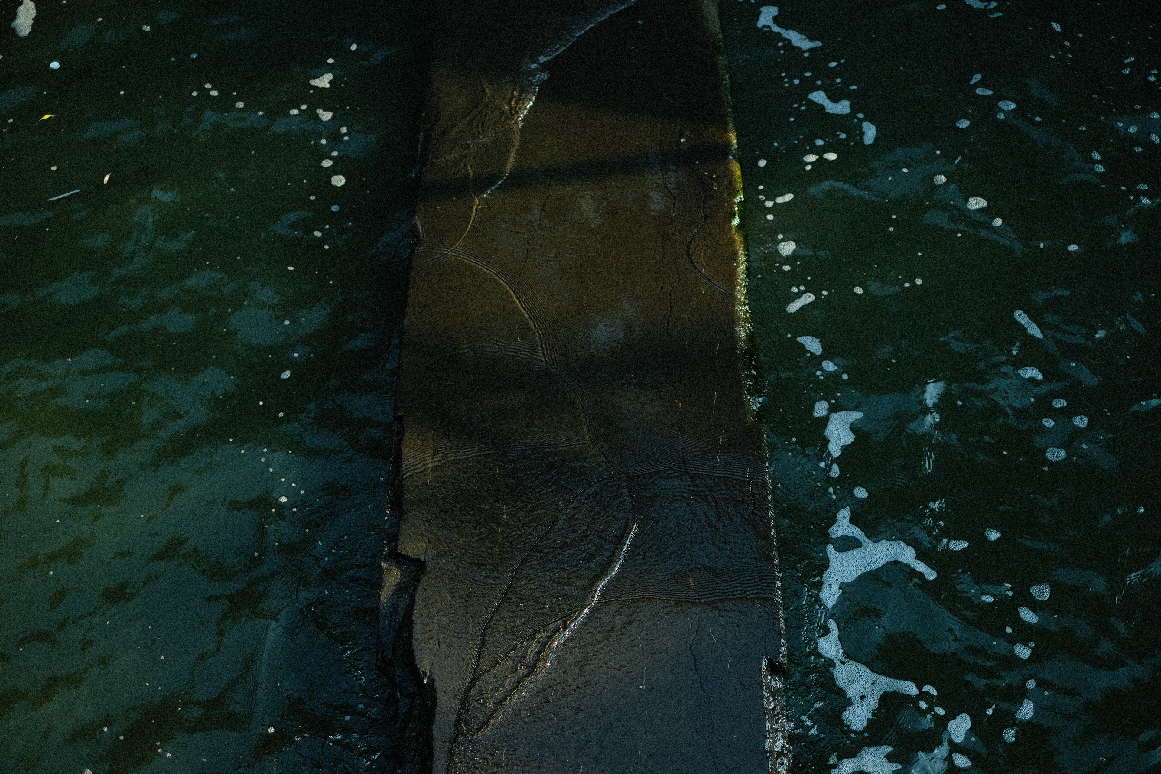 The Hudson washes over concrete