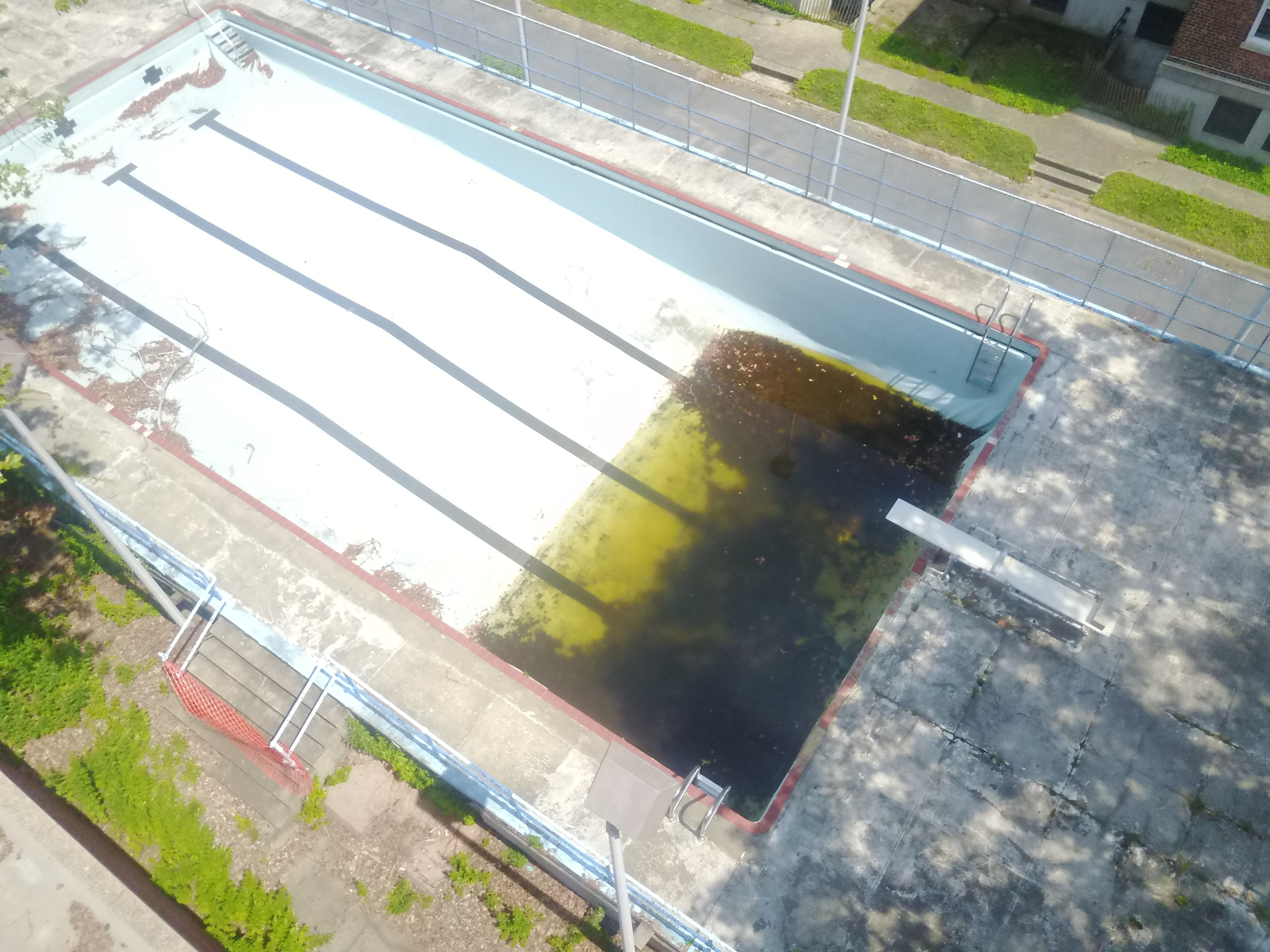 Still from drone flight. Stagnant abandoned pool in former Coast Guard barracks, Governors Island.