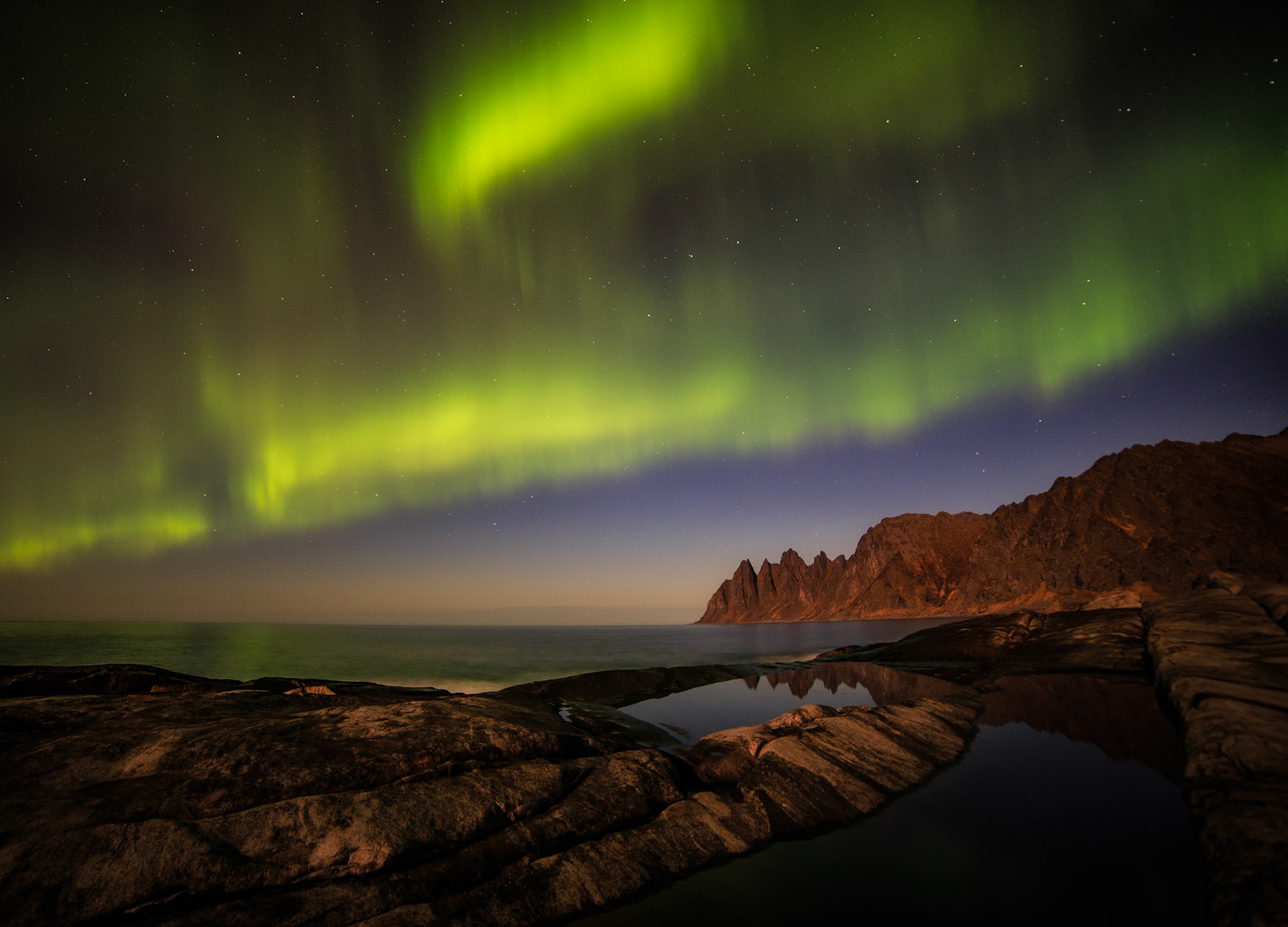 Norway, Dragon Teeth beach, now lighted with Aurora Borealis.