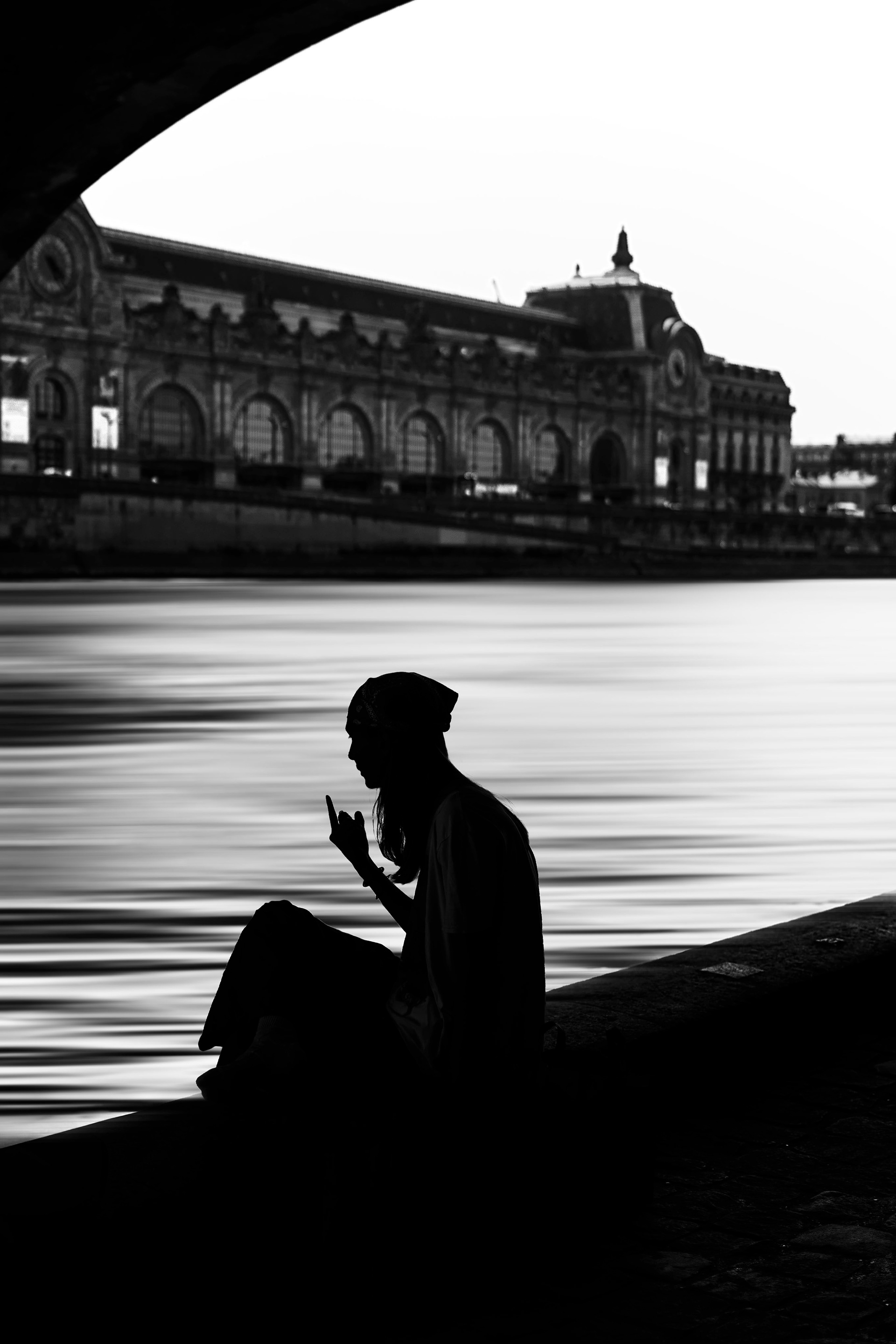 Silhouette by the Seine with the Musée d'Orsay in the background.
