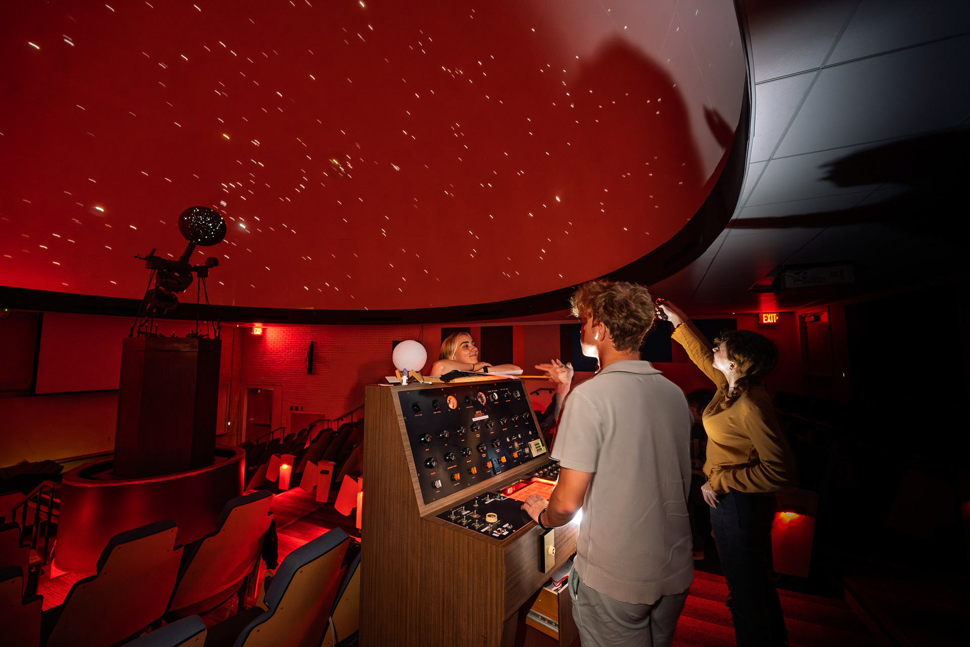 Students explore the night sky inside the campus planetarium.