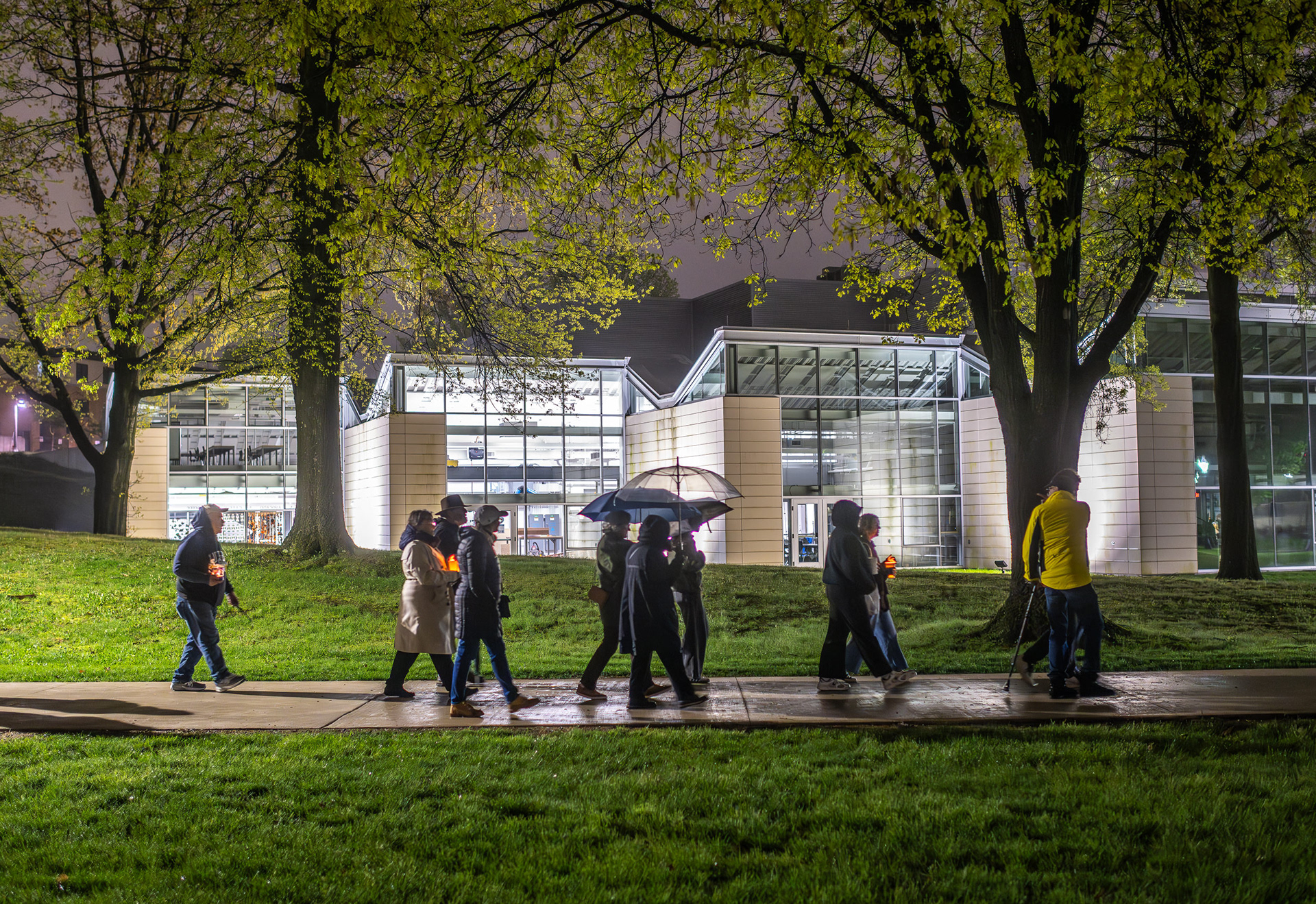 Participants walk through campus during the annual May 4 candlelight vigil.