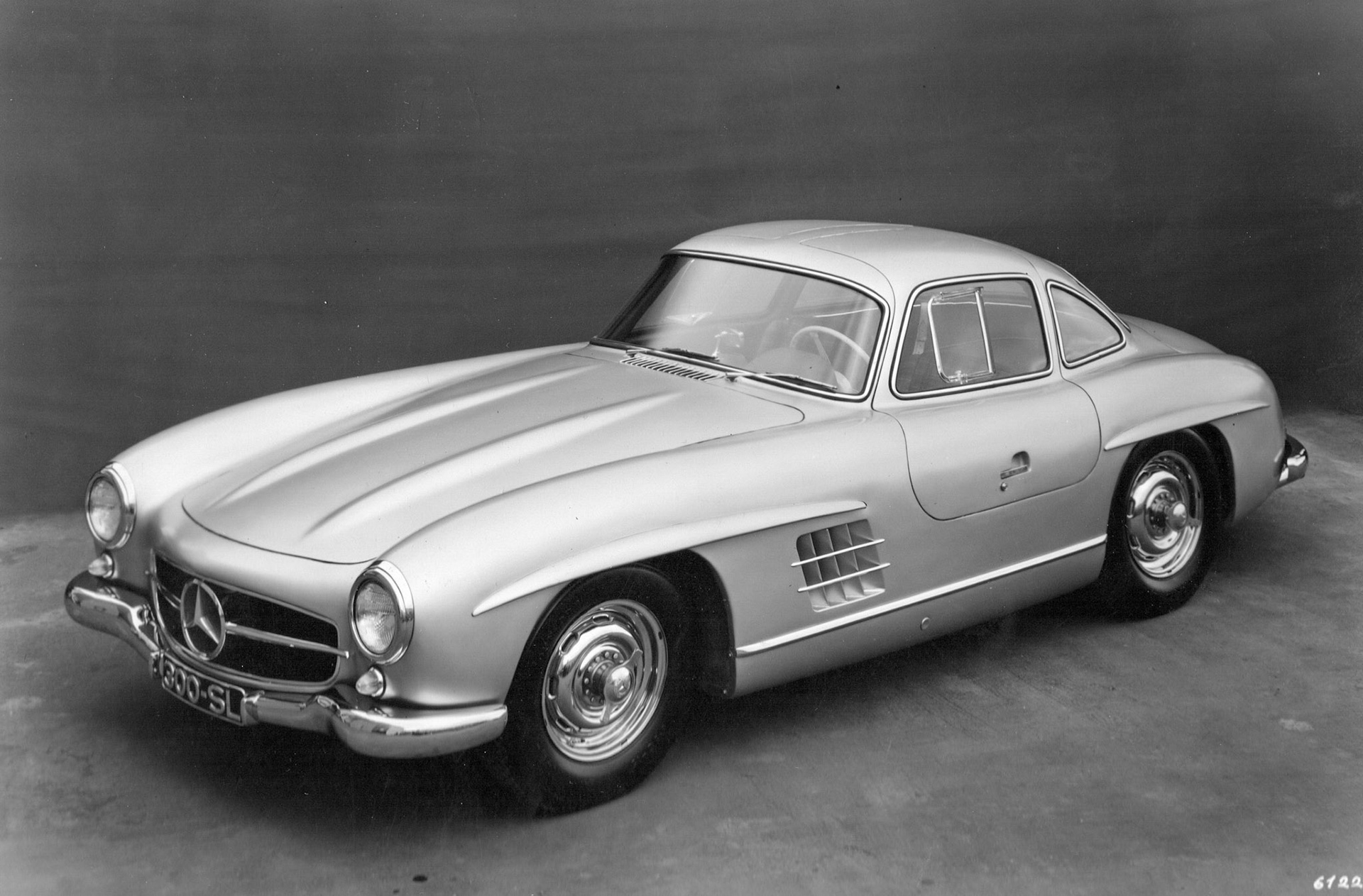 The Mercedes-Benz 300 SL sports coupé was the first car to be offered to the public with petrol injection in place of carburettrors. The 6 cylinder 3 liter engine developed 240 BHP on normal 80 octane petrol. A novel feature about the car is that the doors are hinged on the roof and open upward as on the 1952 Le Mans winning Mercedes. More information on this superb car on a.o. https://emercedesbenz.com/autos/mercedes-benz/sl-class/mercedes-benz-history-the-mercedes-benz-300-sl/.