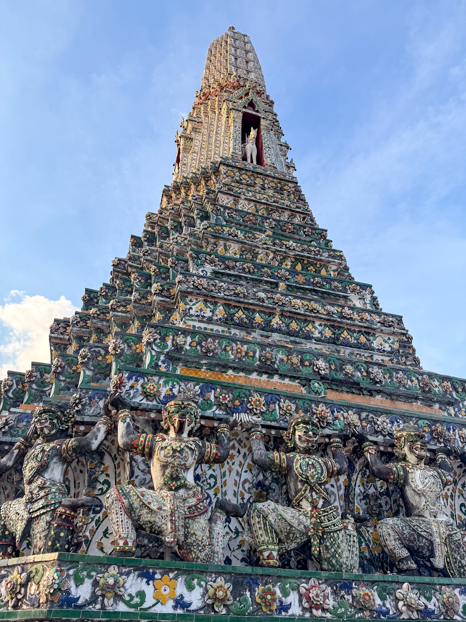 This monumental Buddhist temple is right on the river, with an iconic, ornately tiled central prang (spire)