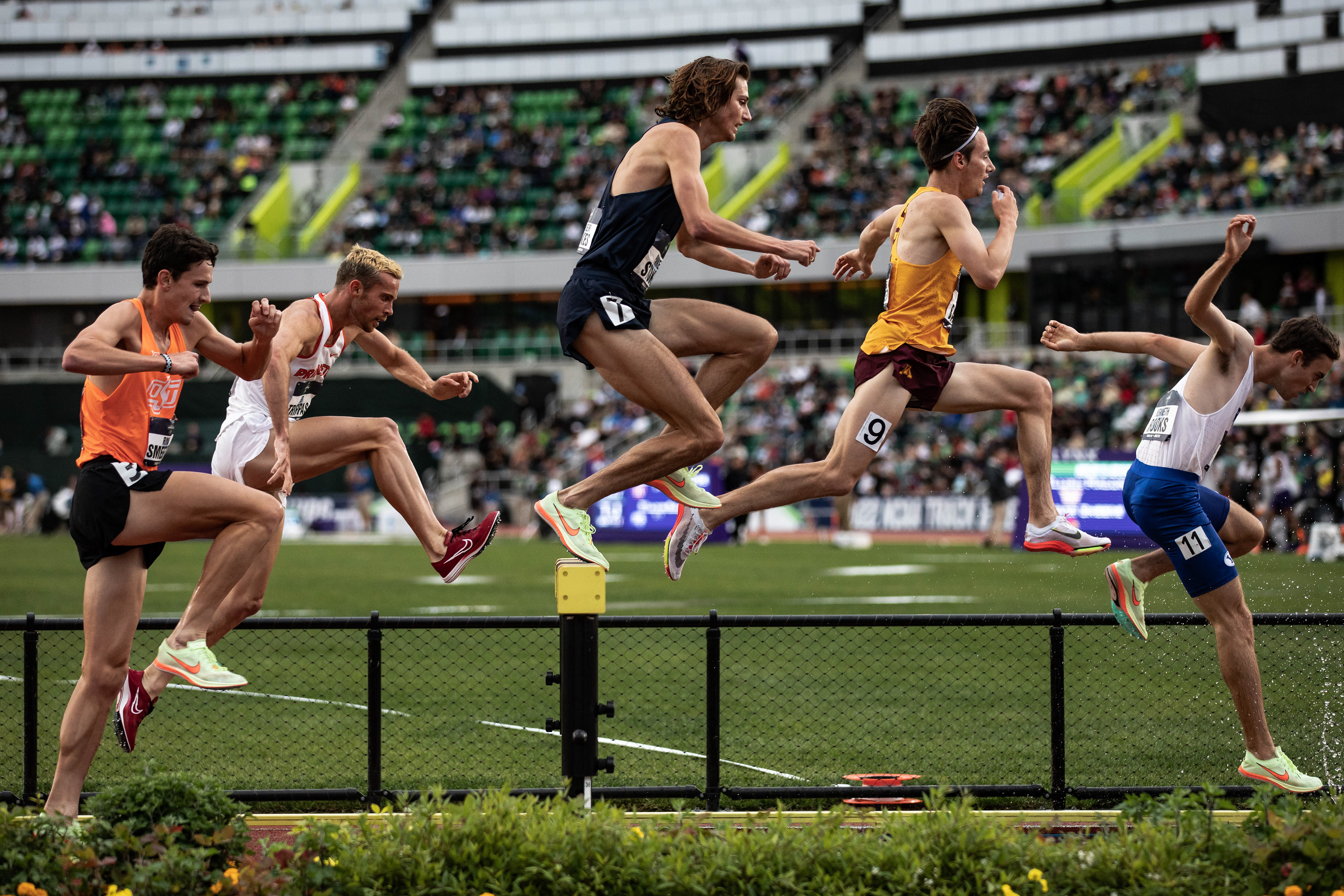 Athletes lunge over the steeplechase in the Mens final 3000m Steeplechase. University of Florida Gators mens track team take home the national championship on the third day of the 2022 NCAA Track & Field Championships at Hayward Field in Eugene, Ore., on June 10th, 2022. (Maddie Stellingwerf/Emerald)