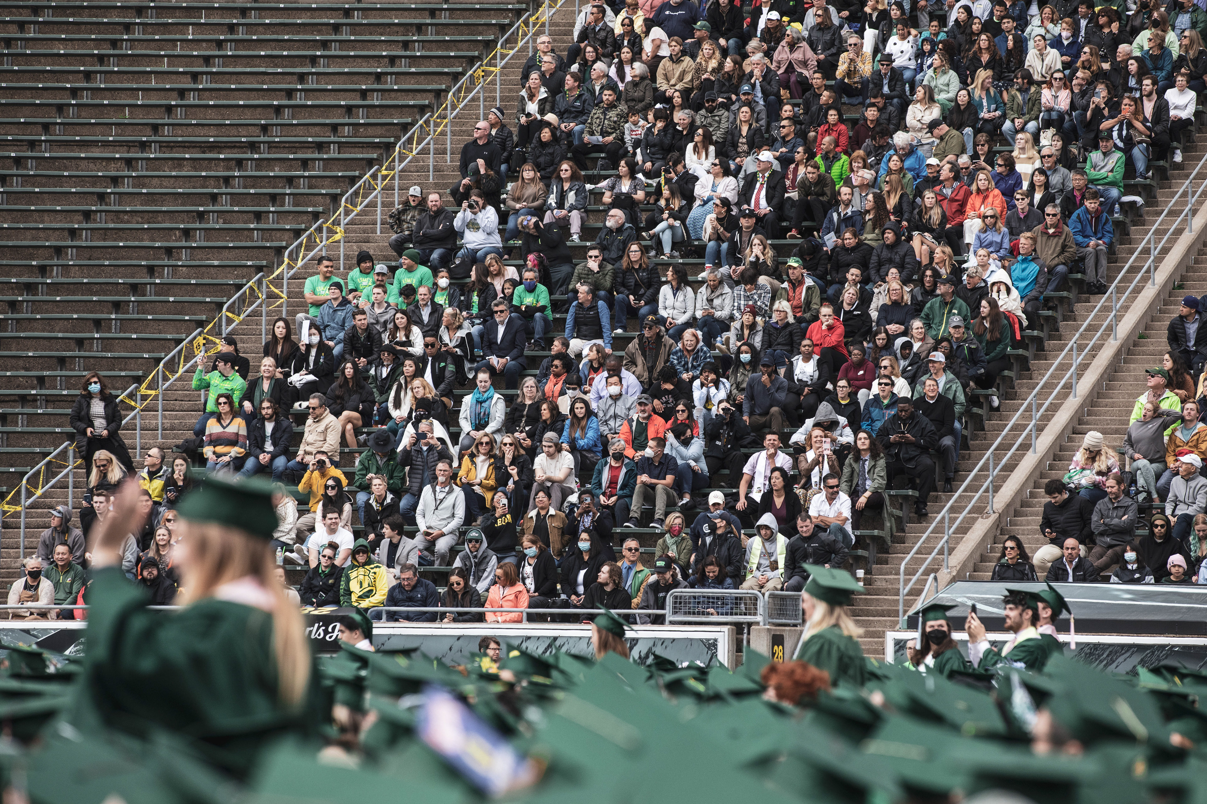 Thousands of friends and families gather to watch multiple classes of UO students graduate for the first formal in-person graduation ceremony in two years. University of Oregon holds its 2022 Commencement Ceremony at Autzen Stadium in Eugene, Ore., on June 13, 2022. (Maddie Stellingwerf/Emerald)