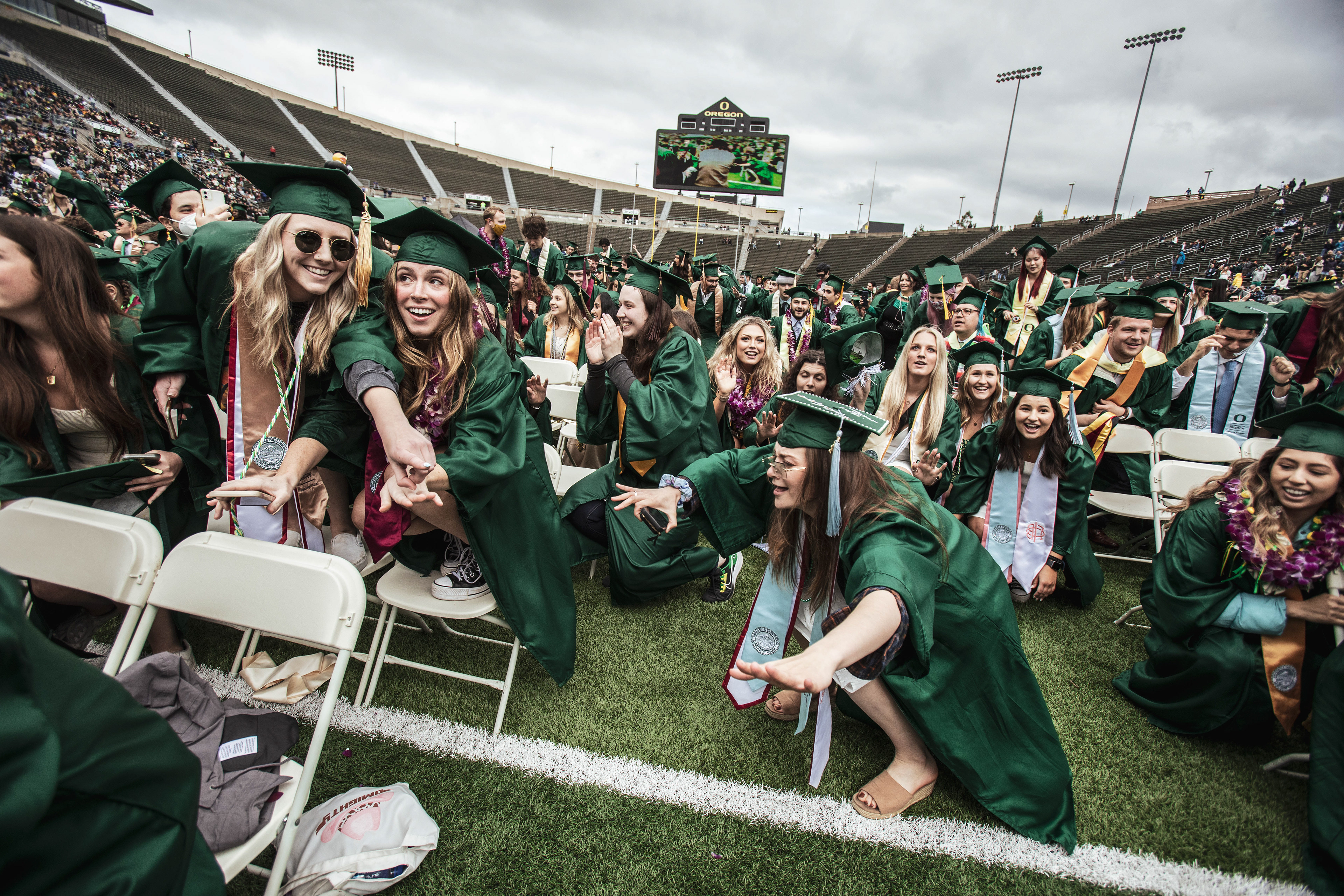 Graduates sing and dance to 'Shout', a song played at almost every UO sporting event. University of Oregon holds its 2022 Commencement Ceremony at Autzen Stadium in Eugene, Ore., on June 13, 2022. (Maddie Stellingwerf/Emerald)