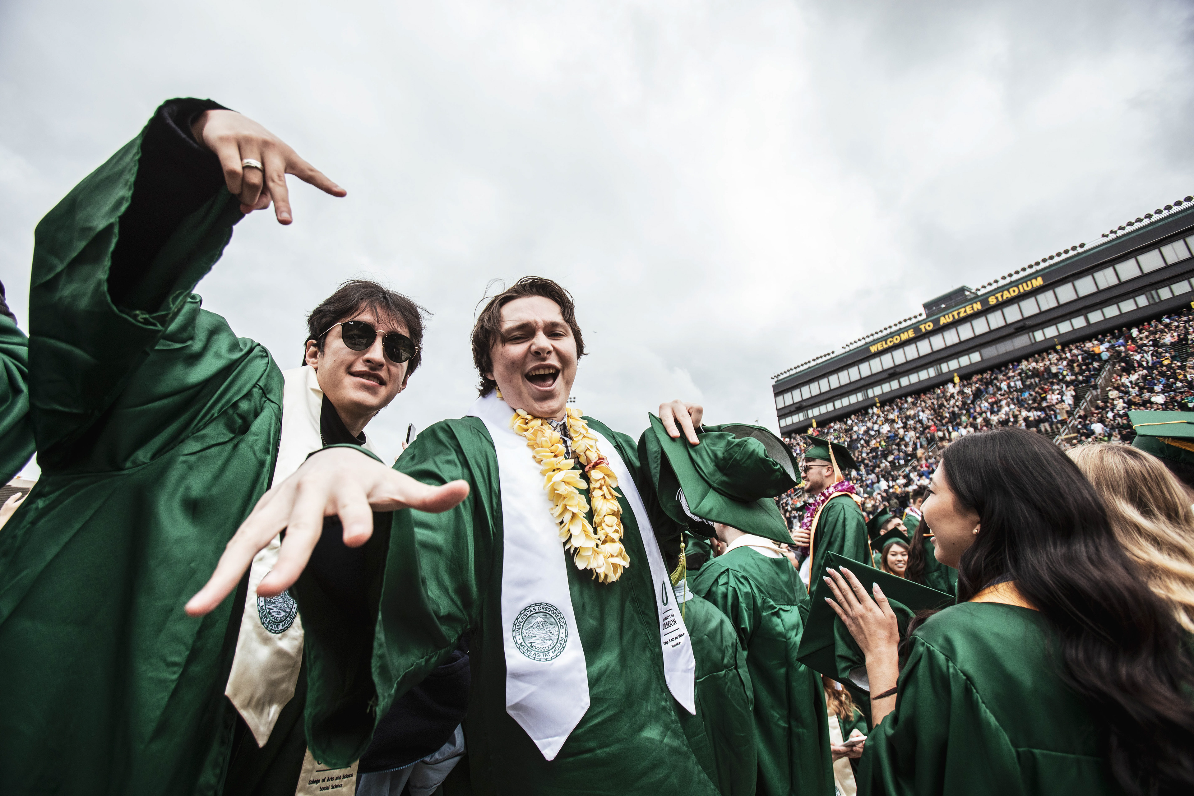 Graduates are all smiles after the commencement ceremony comes to a close and graduation festivities begin. University of Oregon holds its 2022 Commencement Ceremony at Autzen Stadium in Eugene, Ore., on June 13, 2022. (Maddie Stellingwerf/Emerald)