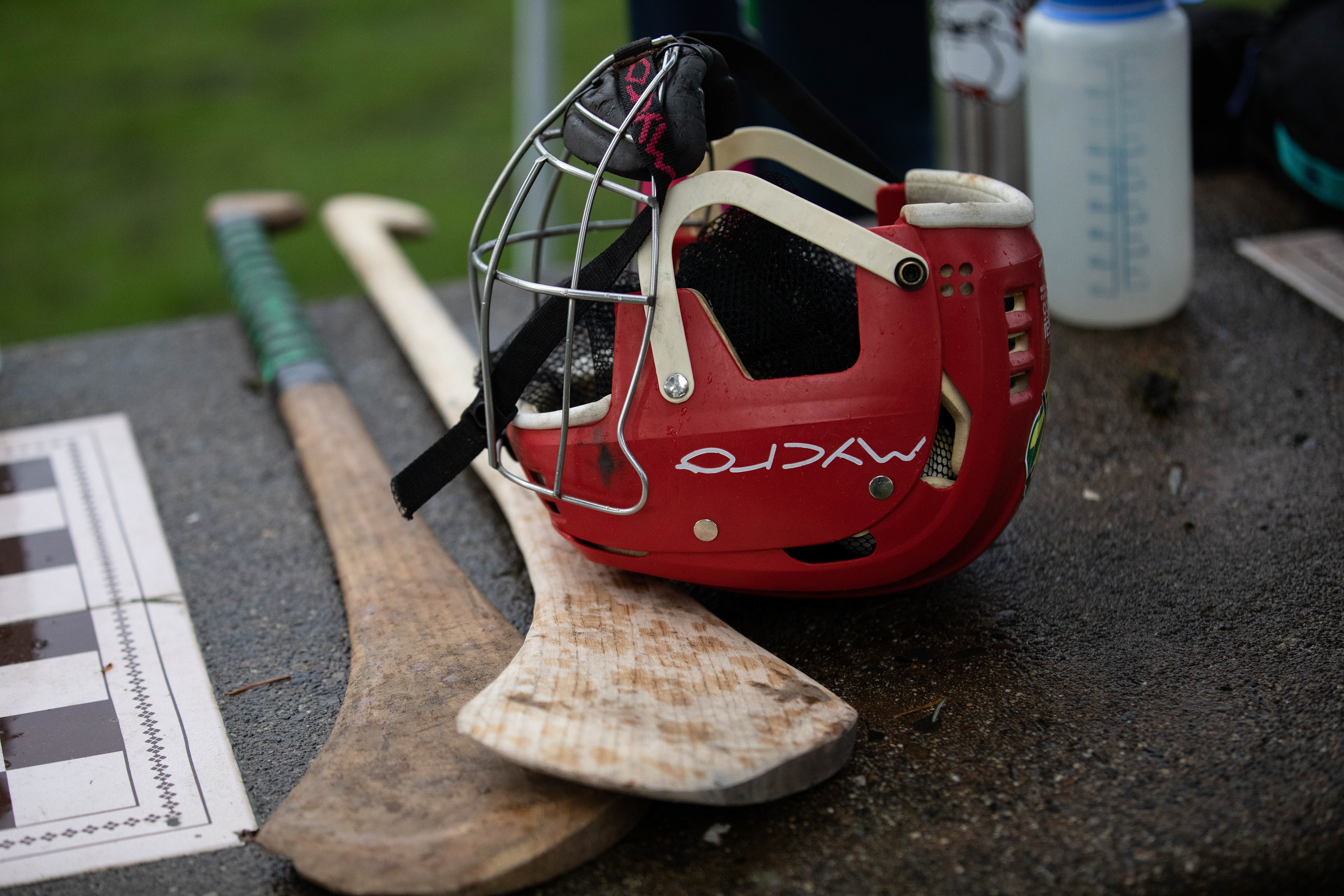 A close up of the equipment used to play Hurling. On the left are the hurley sticks and the right is a helmet needed to safely play. (Maddie Stellingwerf/Emerald)