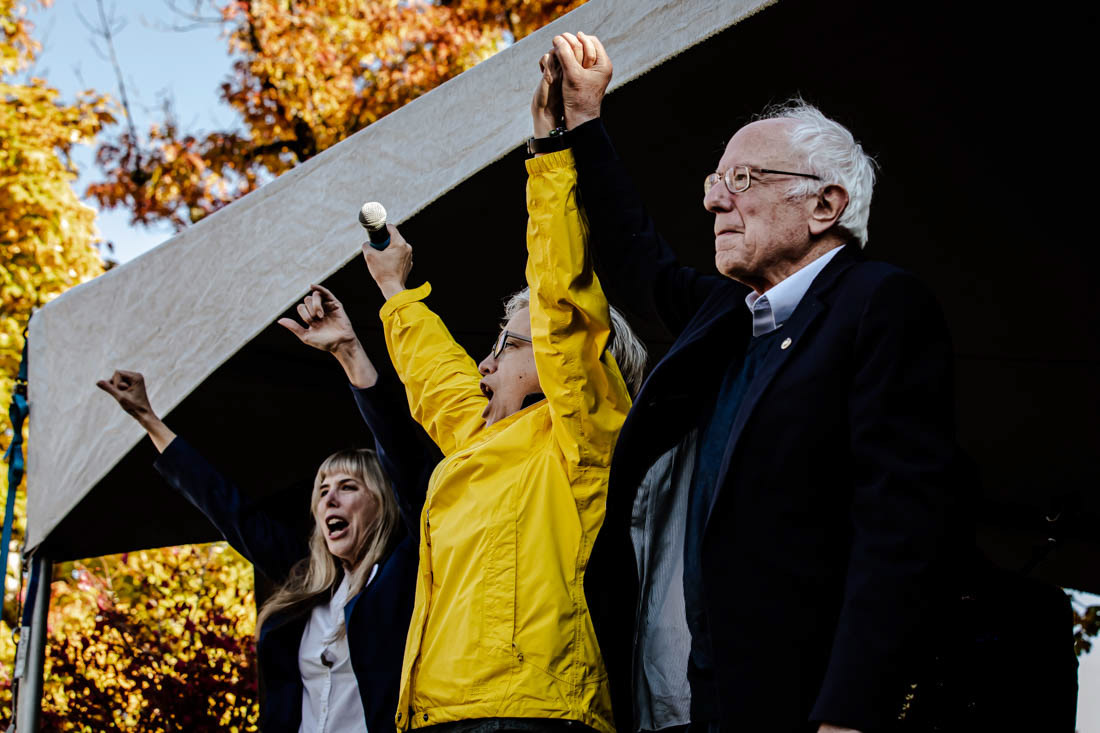 Tina Kotek and Bernie Sanders raise their hands in a joint showing of support for each others political work prior to Sanders speech at the rally. Vermont Senator Bernie Sanders joined Oregon’s Democratic party leaders at the University of Oregon’s Erb Memorial Union for a rally in support of Oregon Democrat Gubernatorial candidate Tina Kotek, on Thursday, Oct., 27th, 2022. (Maddie Stellingwerf/ Emerald)