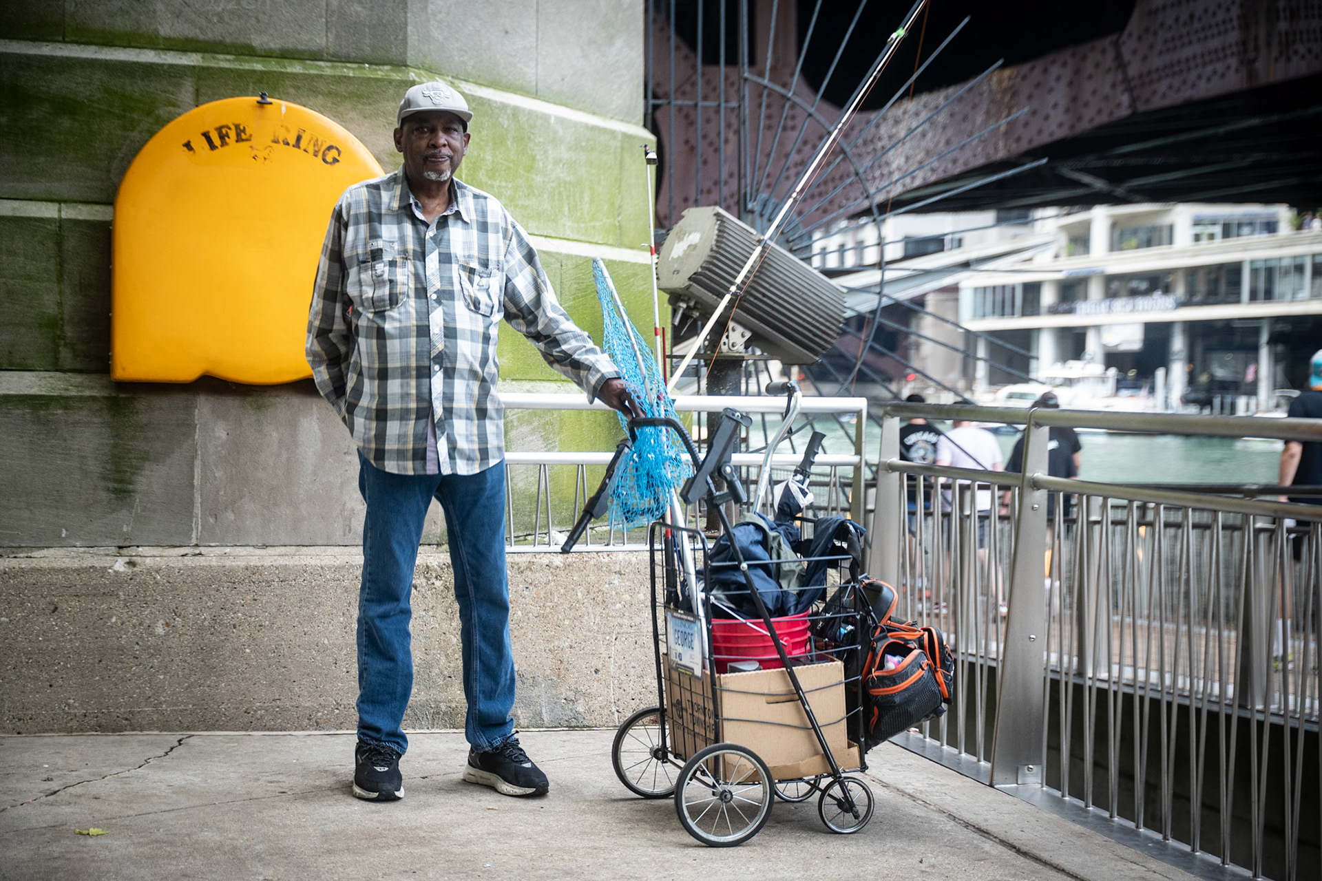George Kelly (72) fishes at the Chicago Riverwalk for NAHJ