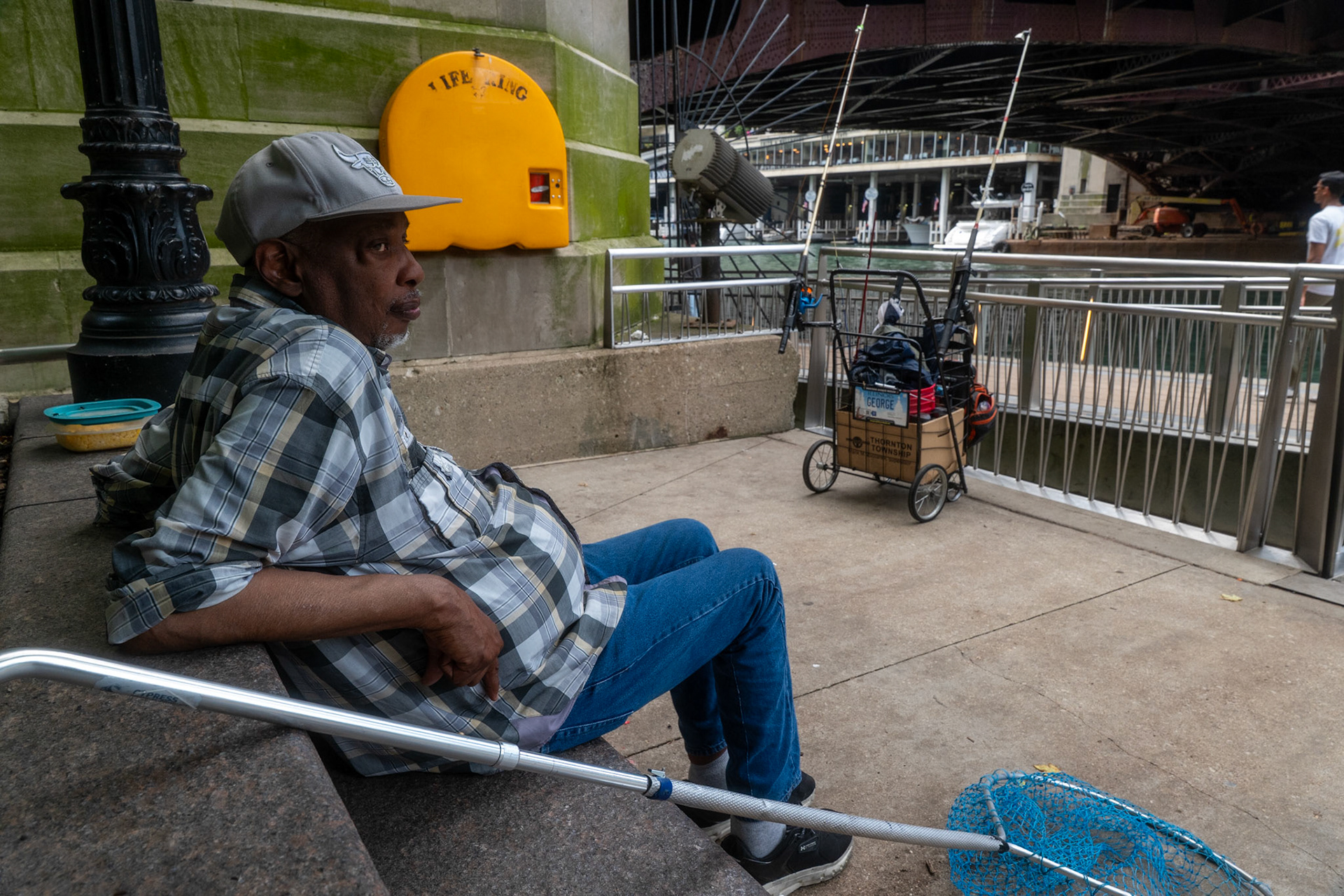 George Kelly (72) fishes at the Chicago Riverwalk for NAHJ