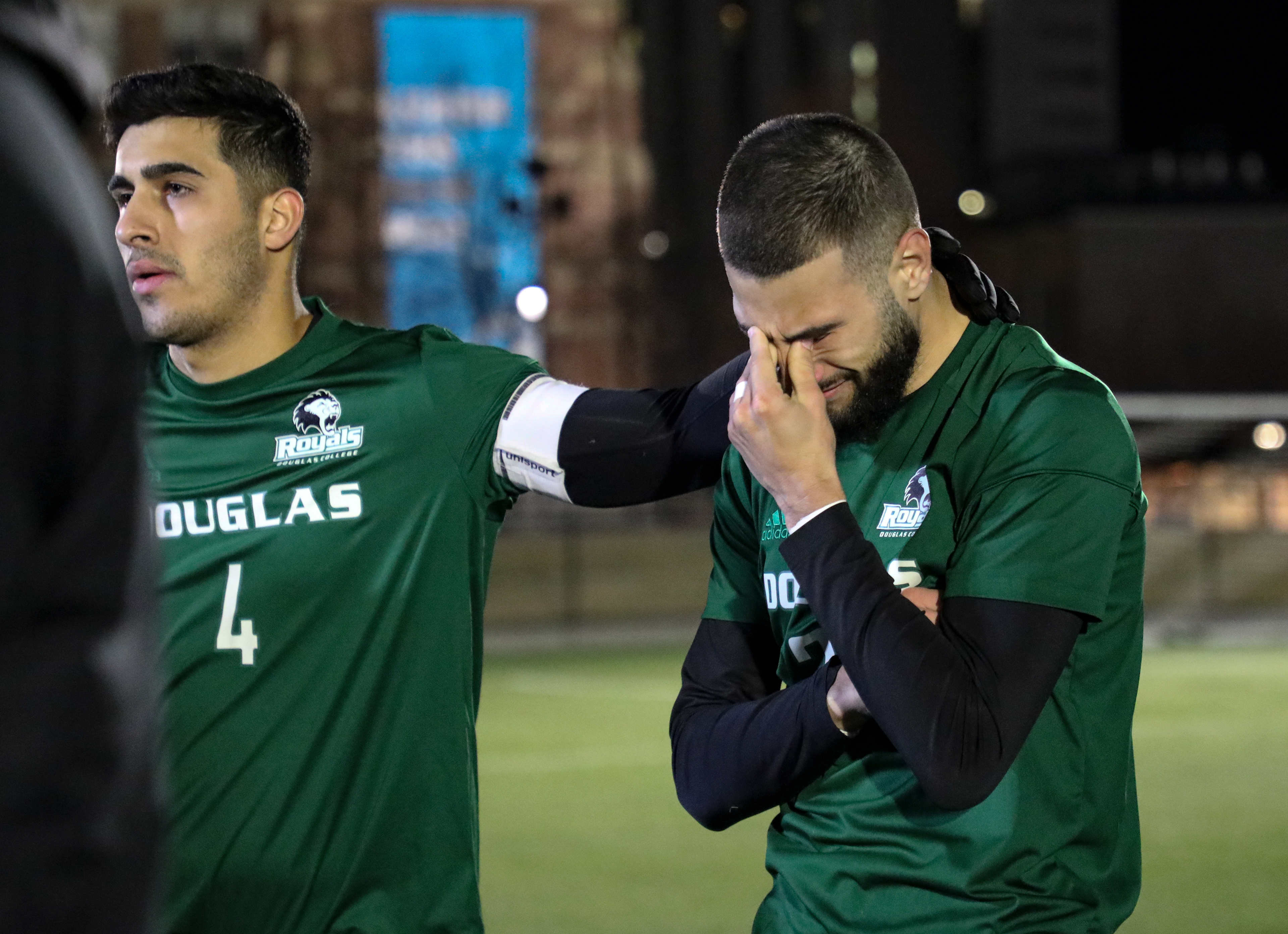 The Douglas College Royals captain Burhan Waisy, left, comforts when defender Yianni Siafakas cries at the awards ceremony after losing to the Humber College Hawks in men’s soccer action.