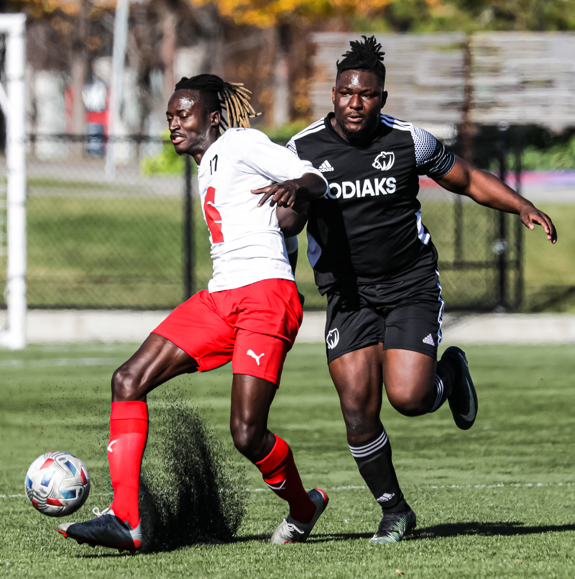 SAIT Trojans Defense Jolly Kopoanomo, left, runs to take the ball against the Lethbridge College Kodiaks at SAIT’s Cohos Commons Field in Calgary on Friday, Oct. 1,2021. The Trojans beat the Kodiaks by a score of 2-1 in Alberta College Athletic Conference men’s soccer action.