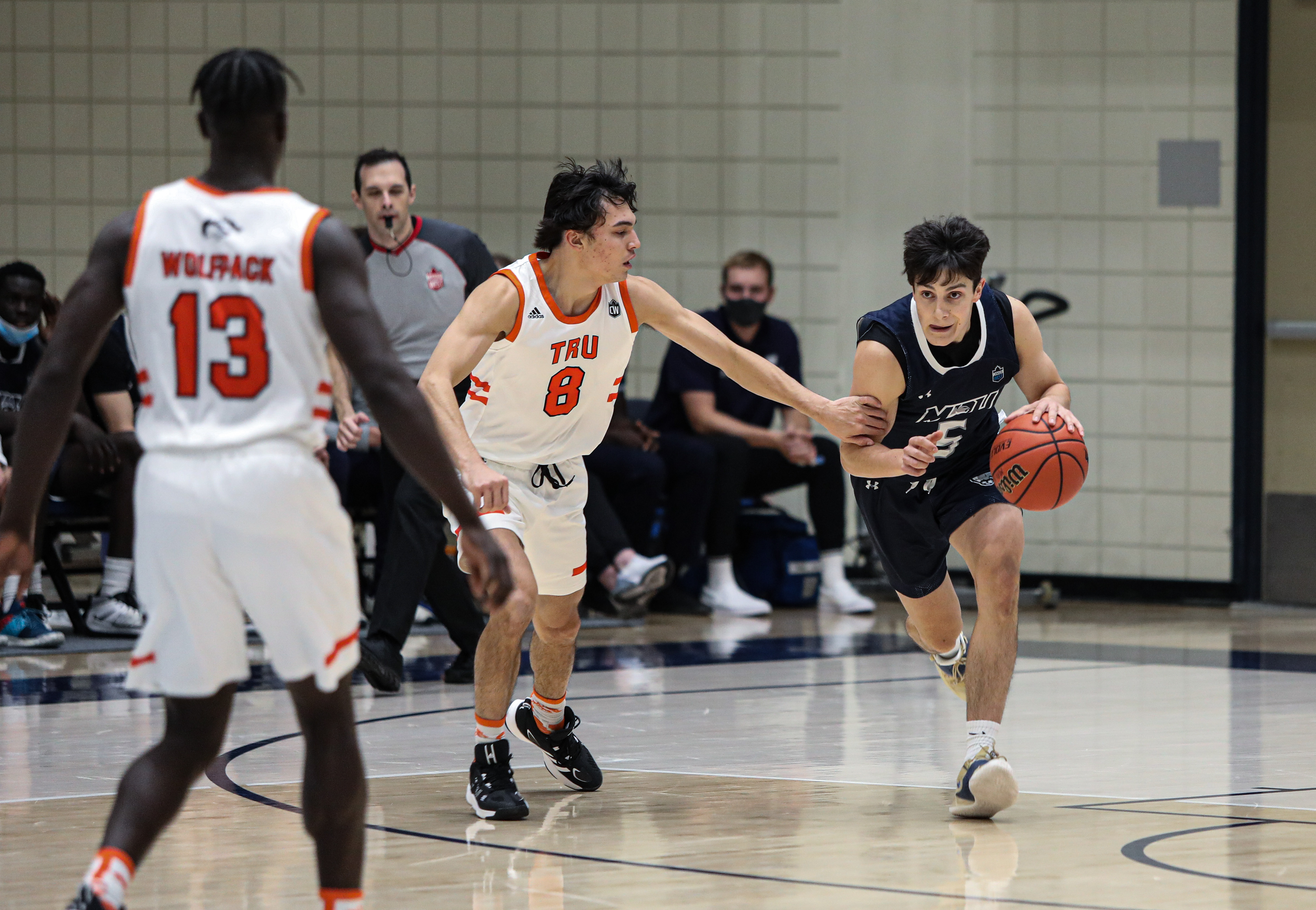 Thompson Rivers University Wolfpack guard Brendan Sullivan, left, blocks Mount Royal University Cougars guard Nate Petrone , right, at the Mount Royal gymnasium in Calgary on Friday, Oct. 15, 2021. The Cougars beat the Wolfpack by a score of 67-66 in Alberta Colleges Athletic Conference men’s basketball action.