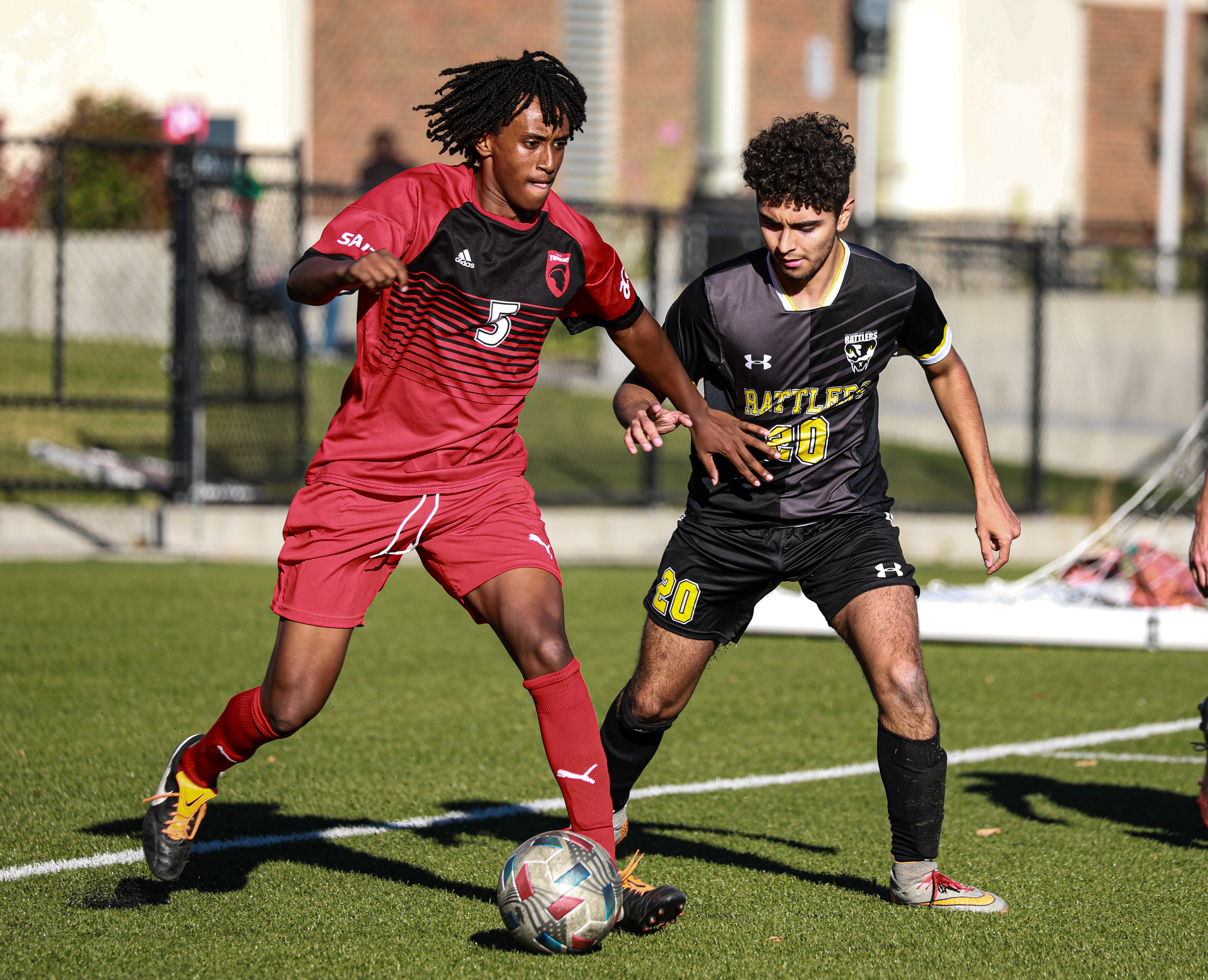 SAIT Trojans Senay Halile,left, runs to take the ball against the Medicine Hat College Rattlers at SAIT’s Cohos Commons Field in Calgary on Sunday, Oct. 3, 2021. The Trojans beat the Rattlers by a score of 2-0 in Alberta College Athletic Conference men’s soccer action.