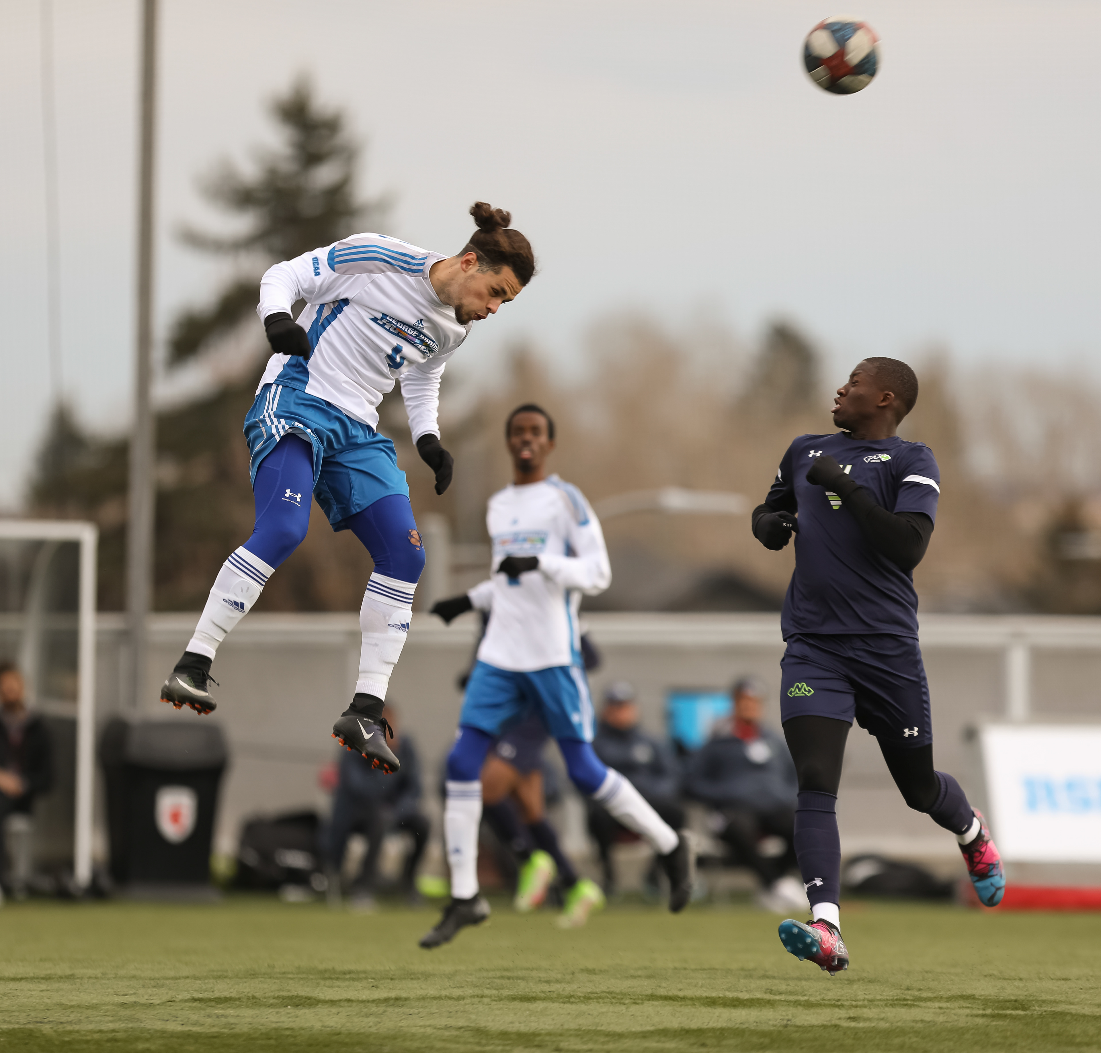 The George Brown College Huskies defender Tiago De Jesus, left, jumps against the Montmorency College Nomades in men’s soccer action.
