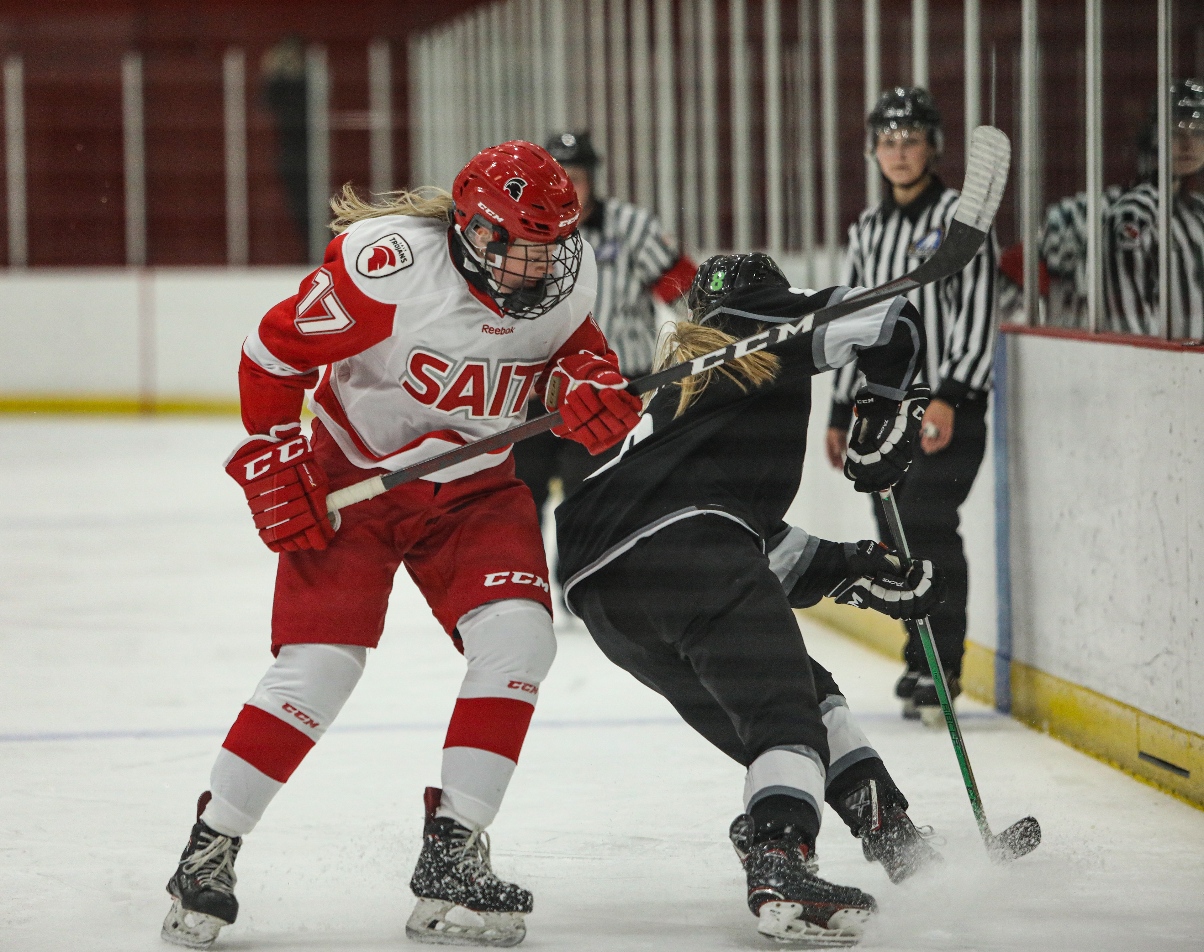 SAIT Trojans defense Kiera Gorrigsen and Red deer player fight during a hockey game at the SAIT arena.