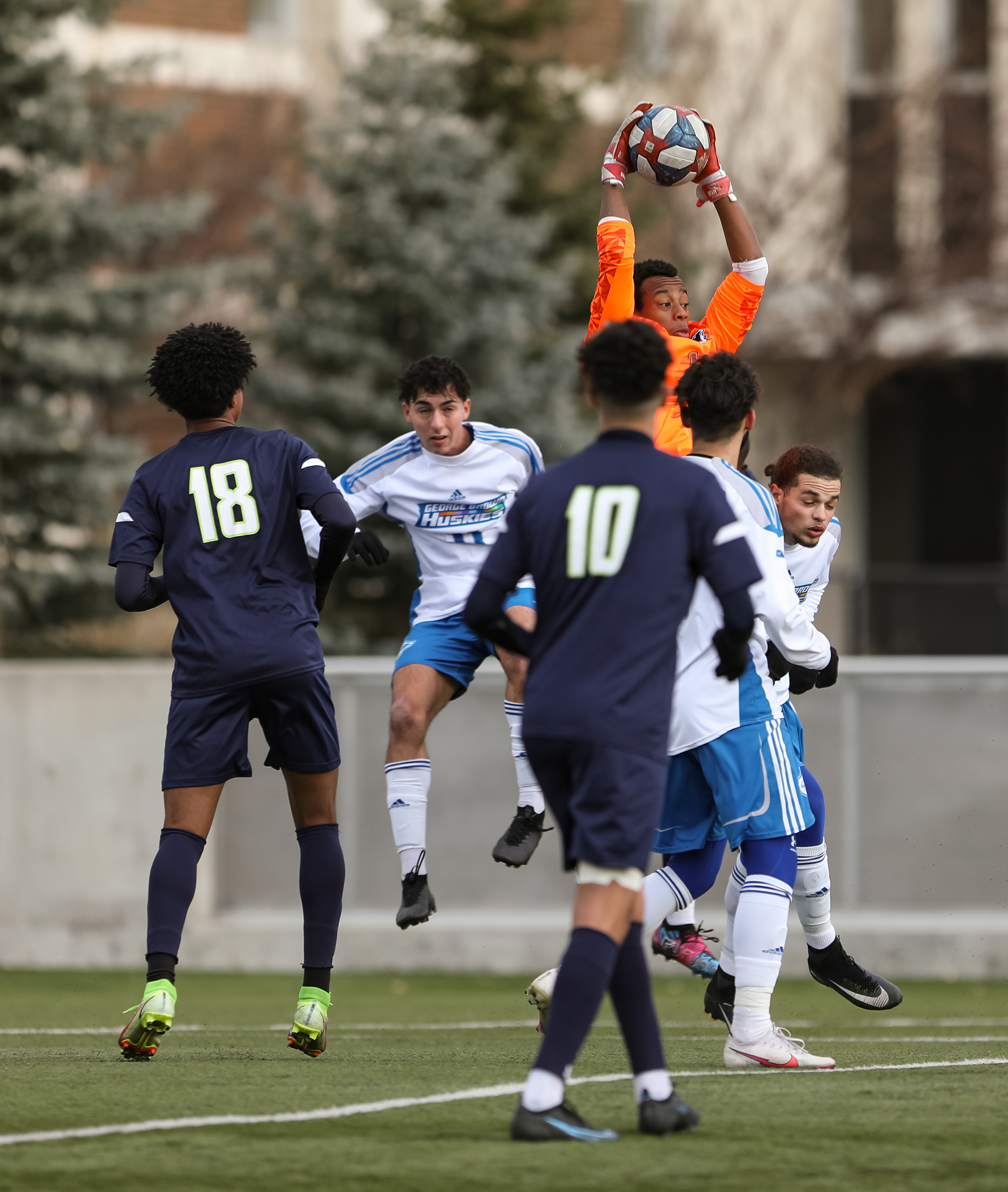 The George Brown College Huskies goalkeeper jumps and catches the ball against the Montmorency College Nomades in men’s soccer action.