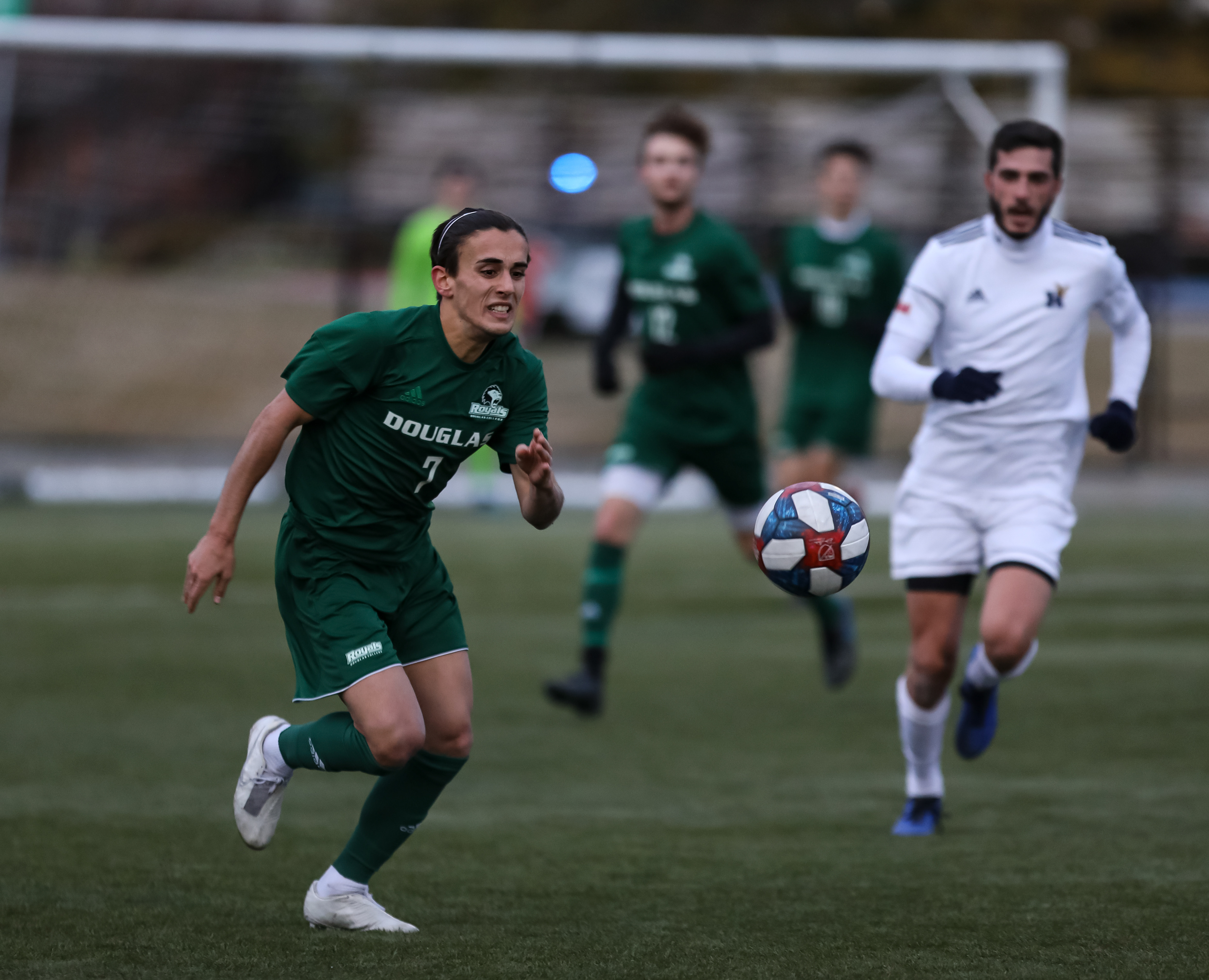 The Douglas College Royals midfielder Mattoe Falcone runs against the Humber College Hawks in men’s soccer action.