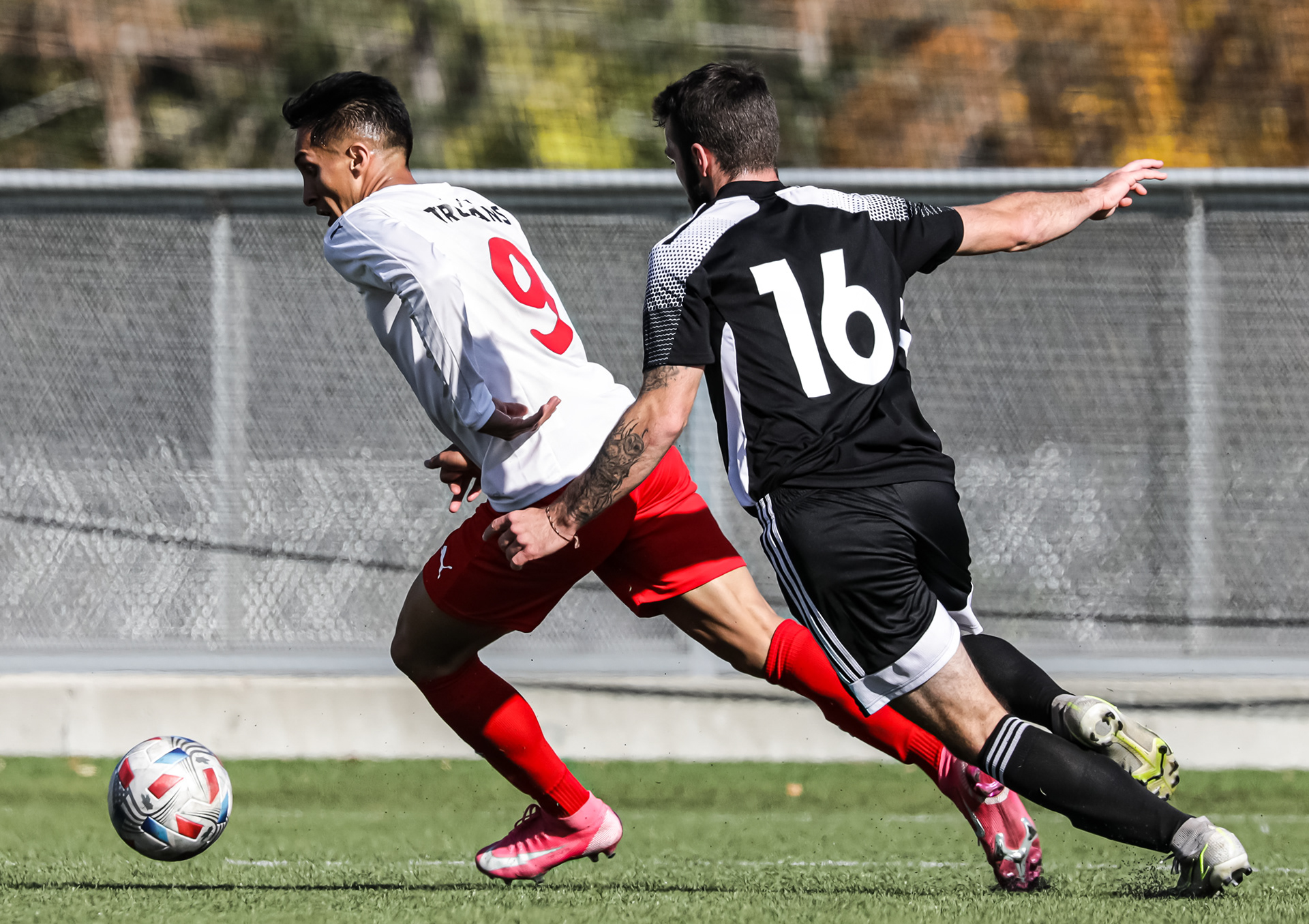 The Lethbridge College Kodiaks center Ben Cull, right, runs to take the ball from SAIT Trojans Midfield Matteo Zanin , left , at SAIT’s Cohos Commons Field in Calgary on Friday, Oct. 1,2021. The Trojans beat the Kodiaks by a score of 2-1 in Alberta College Athletic Conference men’s soccer action.