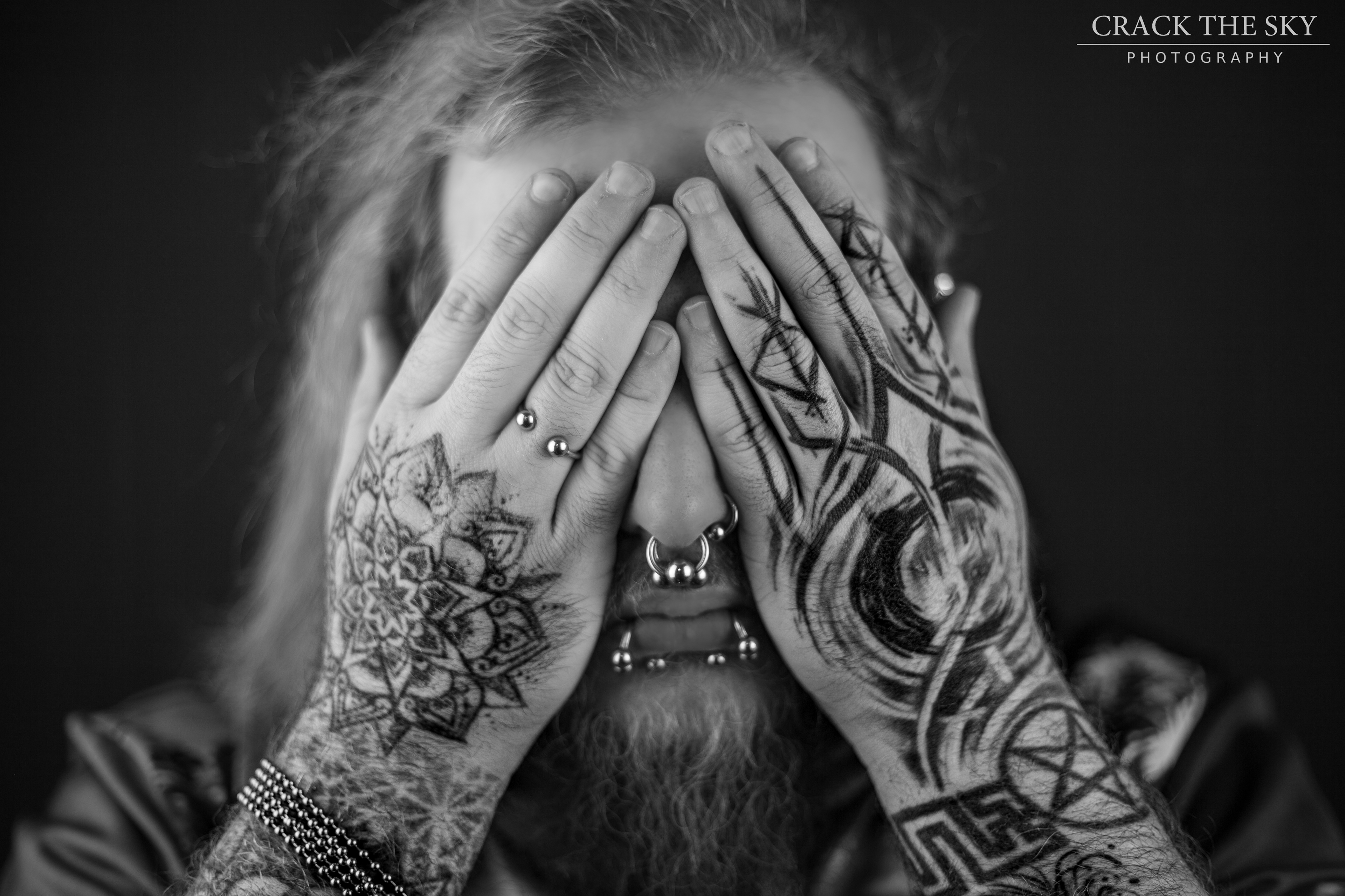 Hand and arm tattoos with acial piercings (Double septum, left nostril, double snake bites (shark bites)