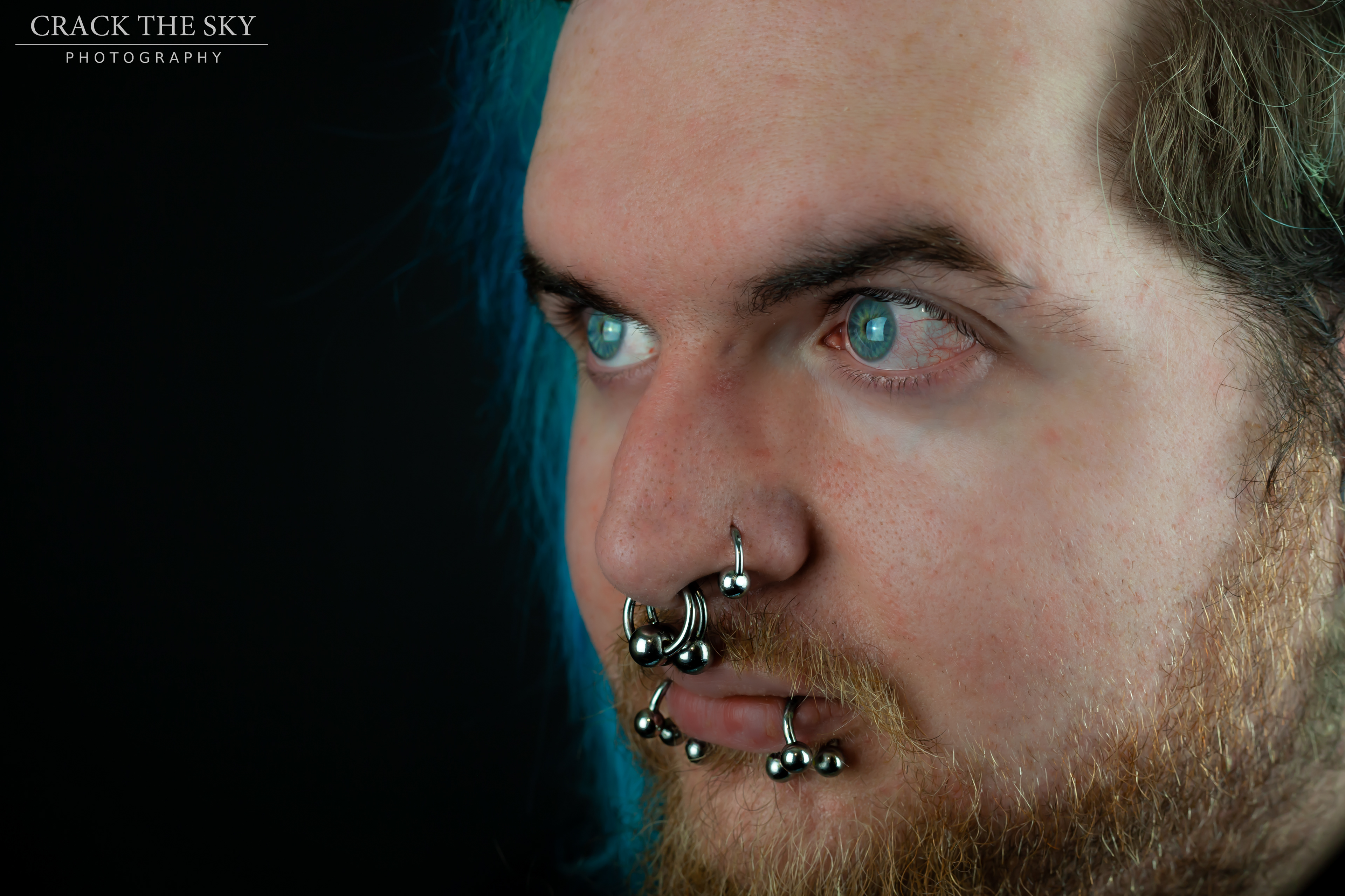 Facial piercings (Double septum, left nostril, double snake bites (shark bites)