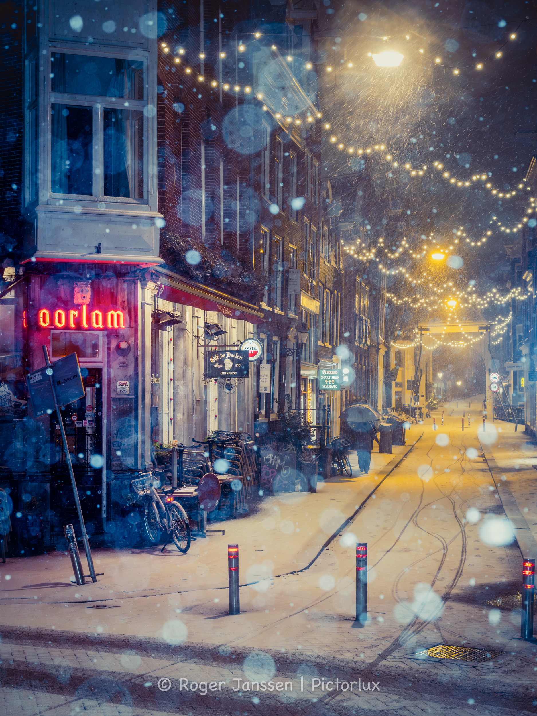 Some pedestrians during a blizzard in the Staalstraat near Café de Doelen in Amsterdam.