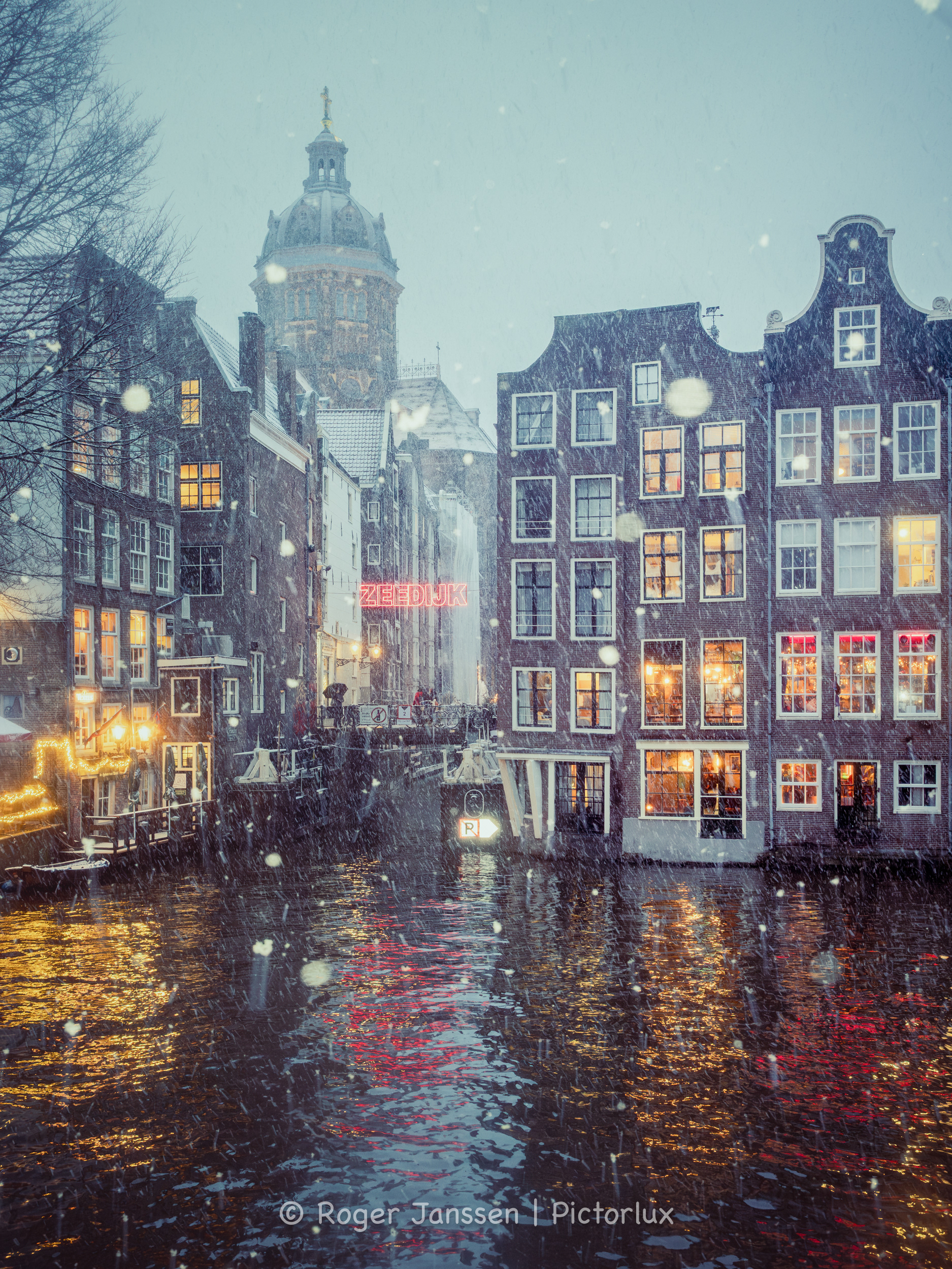 A view on the St. Nicholas Basilik, The Haven van Texel and bar The Queen's Head from the Oudezijdsvoorburgwal in Amsterdam.