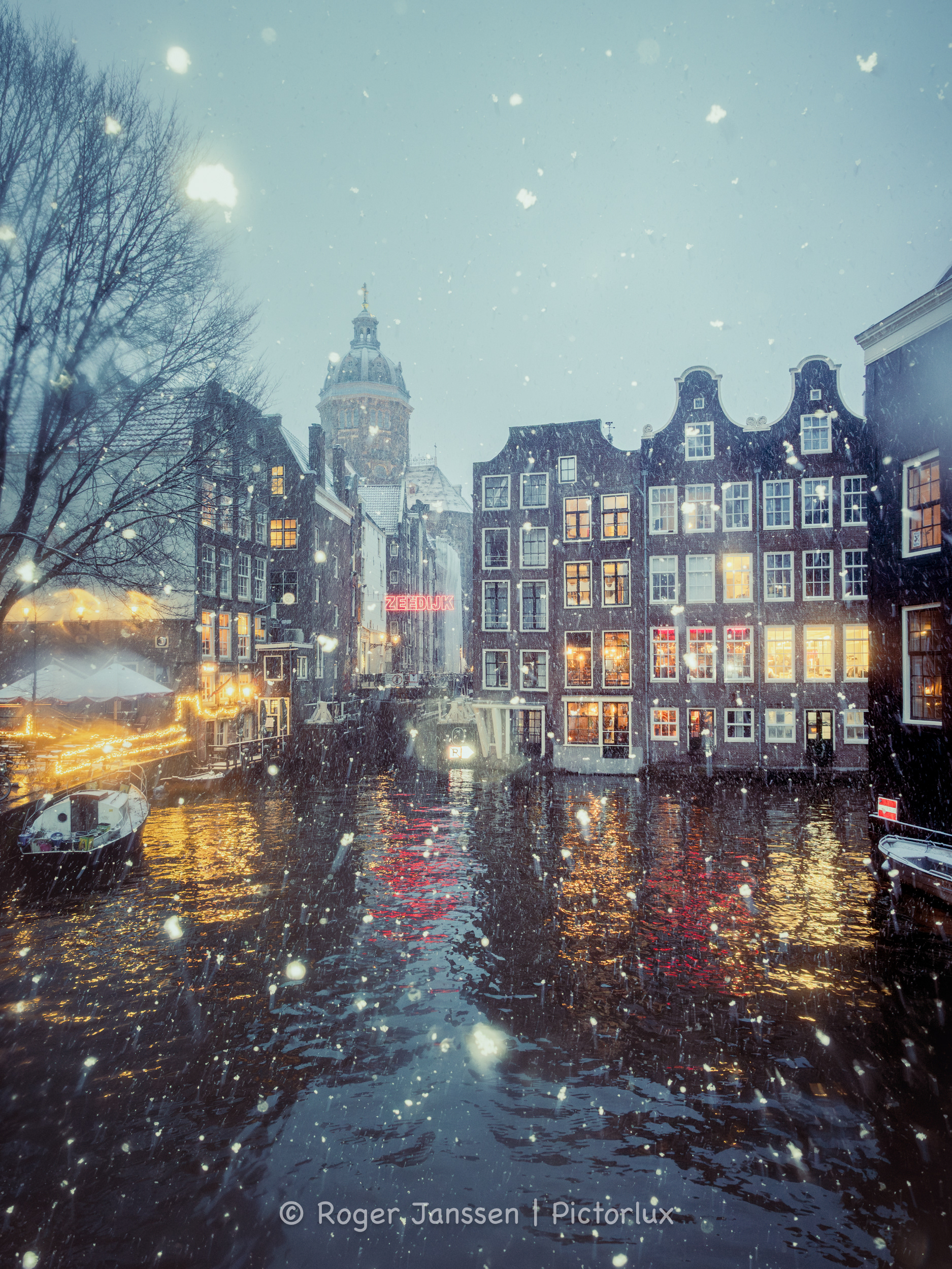 A view on the St. Nicholas Basilik, The Haven van Texel and bar The Queen's Head from the Oudezijdsvoorburgwal in Amsterdam.