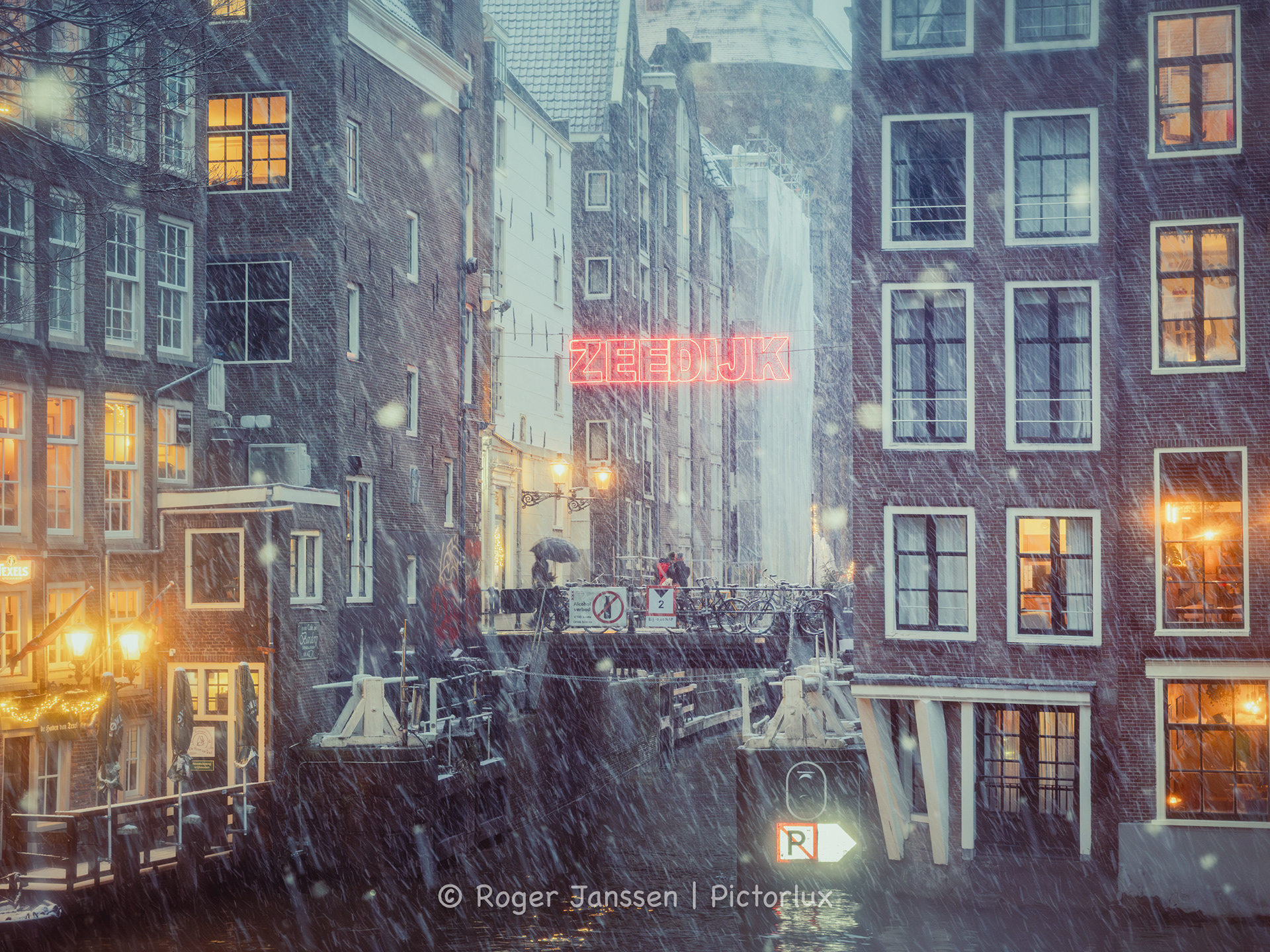 A view on the St. Nicholas Basilik, The Haven van Texel and bar The Queen's Head from the Oudezijdsvoorburgwal in Amsterdam.