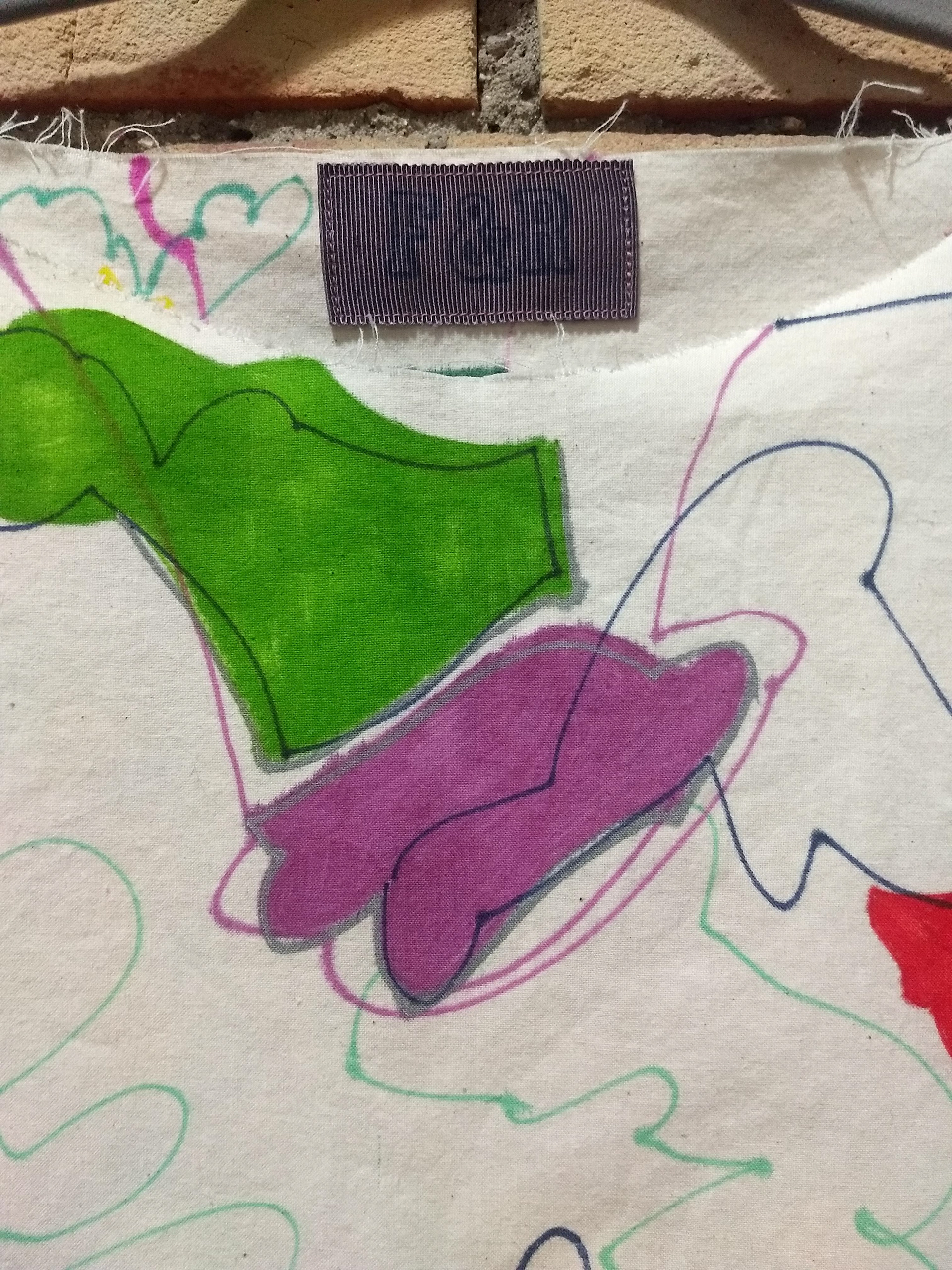 Detail tunic label and artwork