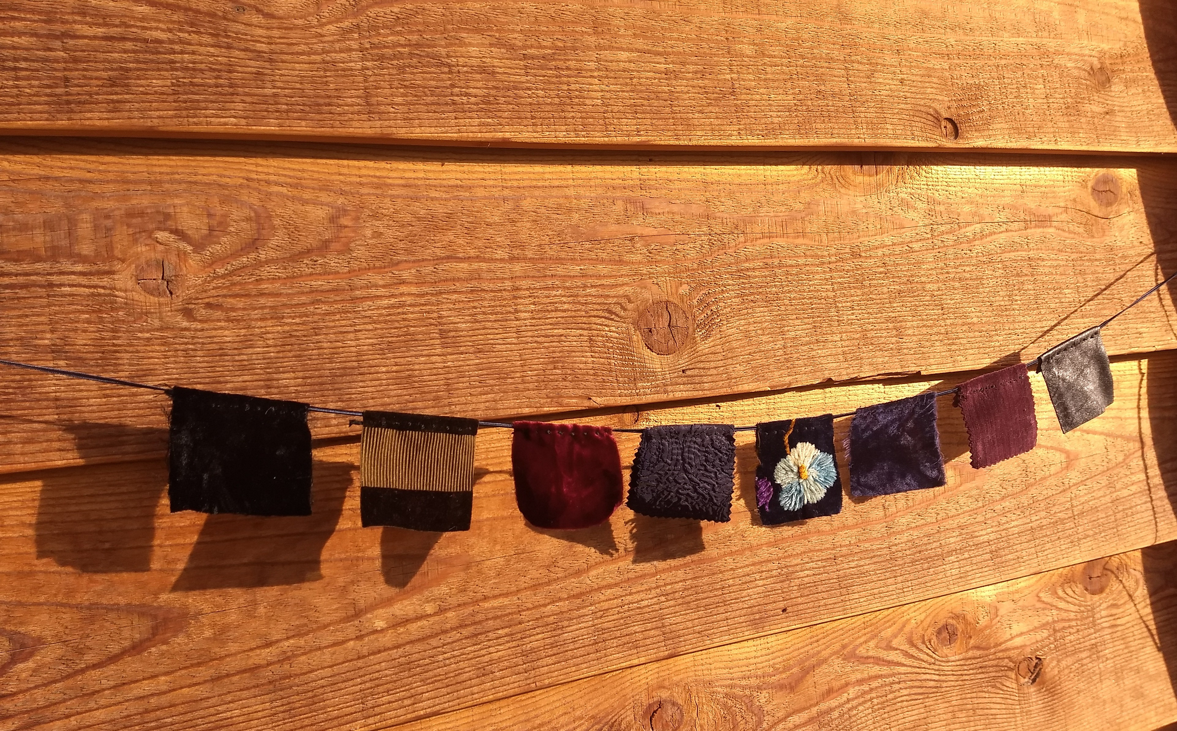 SOLD #8 Material Progress, Qualities: Broad, Powerful and Inclusive/ Measurements: pennants end to end 27" - cording end on each side 24" - each square pennant 2.5" x 2.5"